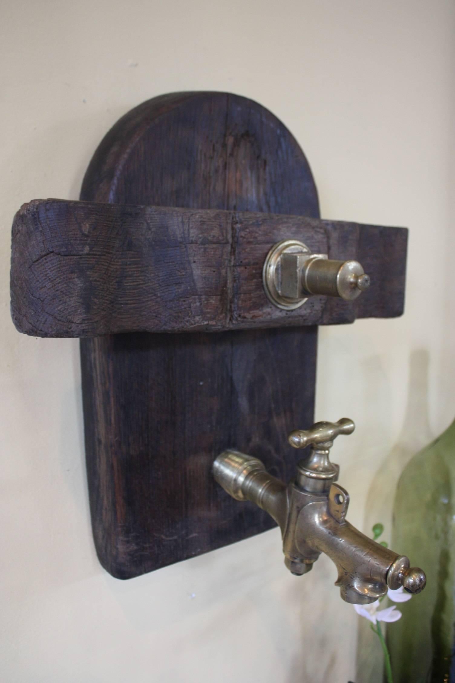 French wine barrel door with bronze spout. Makes a really good conversation piece and would look great hanging in a wine cellar.
