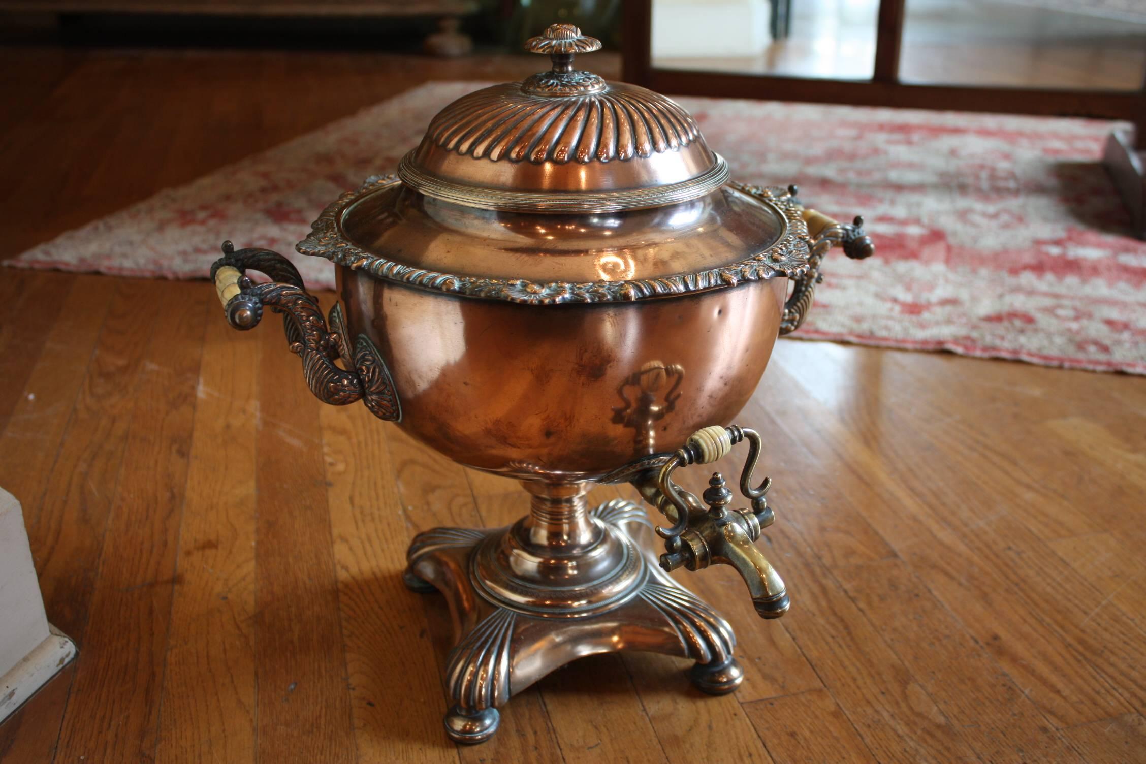 A large French samovar (or tea urn) of copper and brass, featuring a removable domed top with finial, a lovely copper and brass body with bone handles, a large brass spigot with bone tap, mounted to a footed base.

Makes a great lamp or