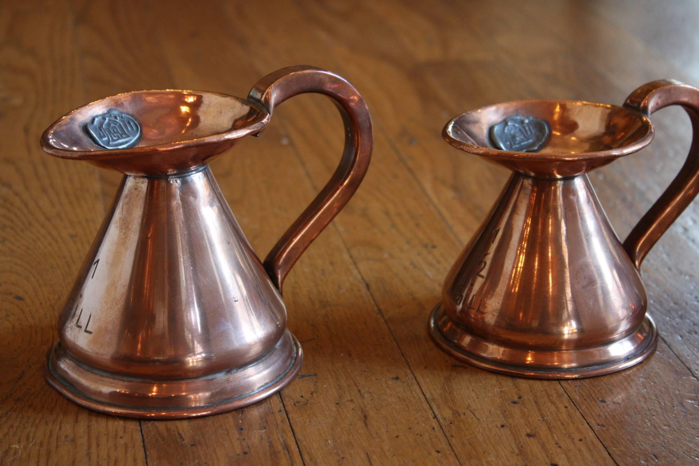 A matched set of four 19th century English copper pitchers (stamped Victorian), four sizes, 1 gill to 1/4 gill.