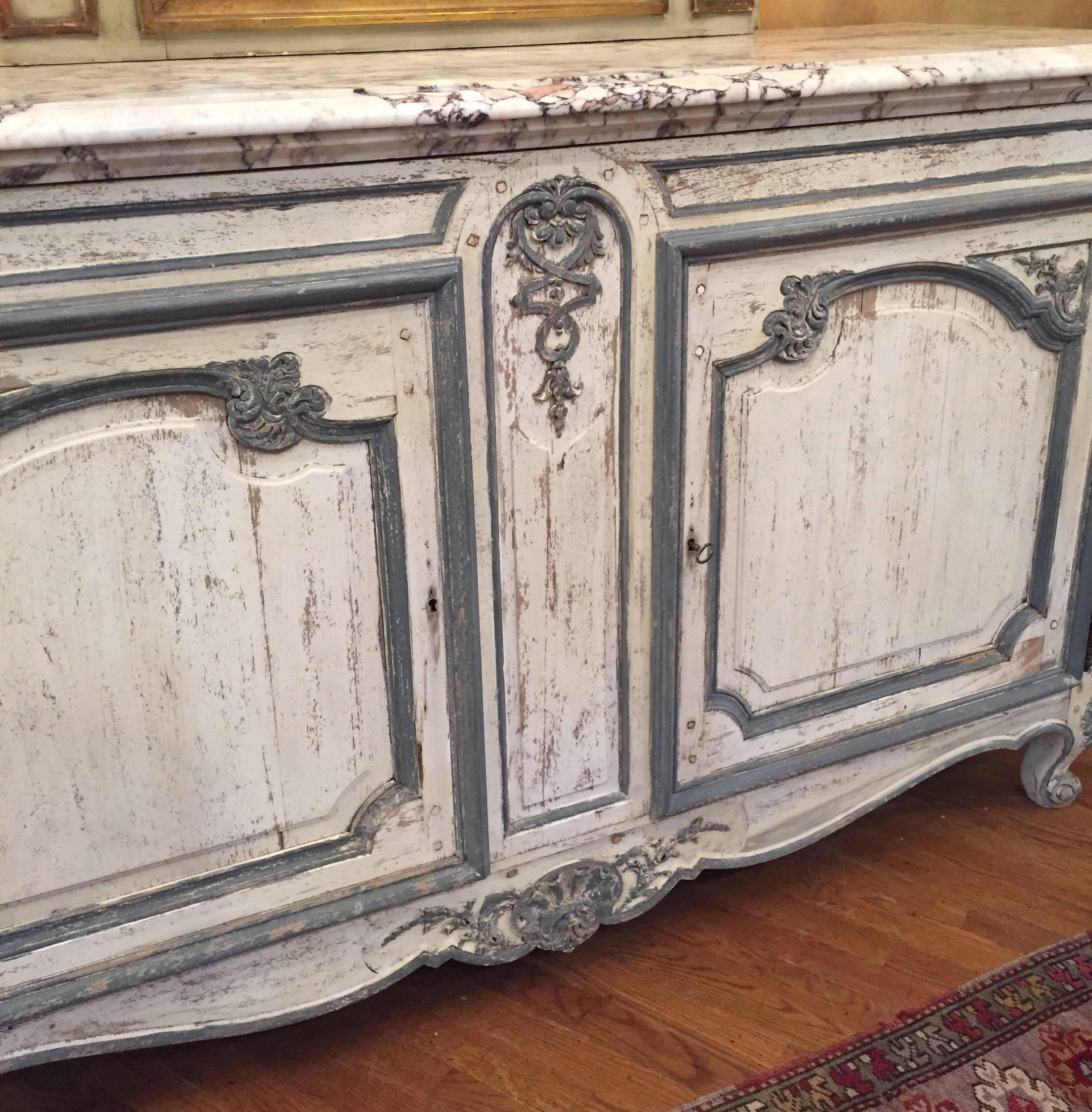 This is a really great looking painted French buffet, enfilade, with a very unique marble top and painted in a beautiful French blue and white. The size and marble top lends this piece into making the perfect vanity.