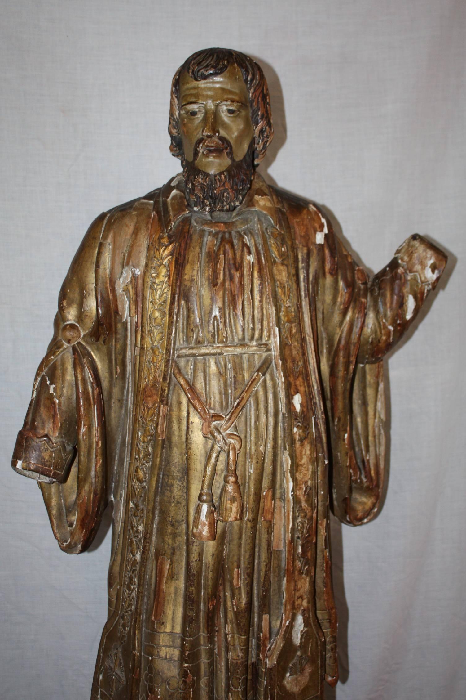 This is a very nice French religious statue that dates to the 1700s. It is a carving of Saint Francis Xavier. The figure is wearing a religious stole. The original wood carving was covered in a gesso plaster and upon the stole had decorative plaster
