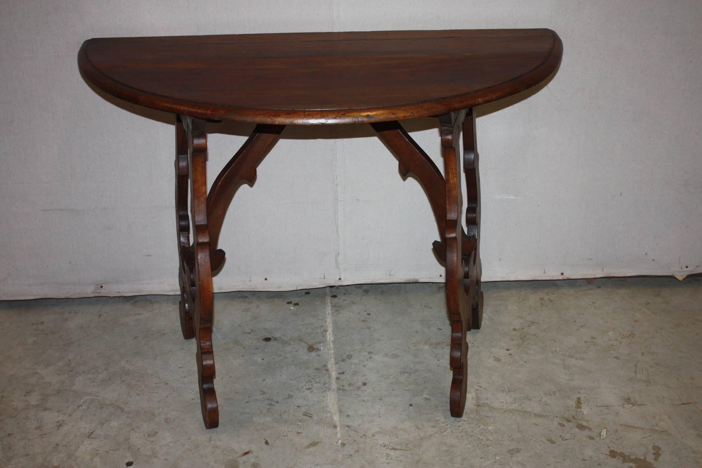 This is a very fine example of an Italian walnut console.  The patina of the wood is rich.  The design is very desirable.  This is very typical of an Italian demi-loom console.  It has very nice dimensions.