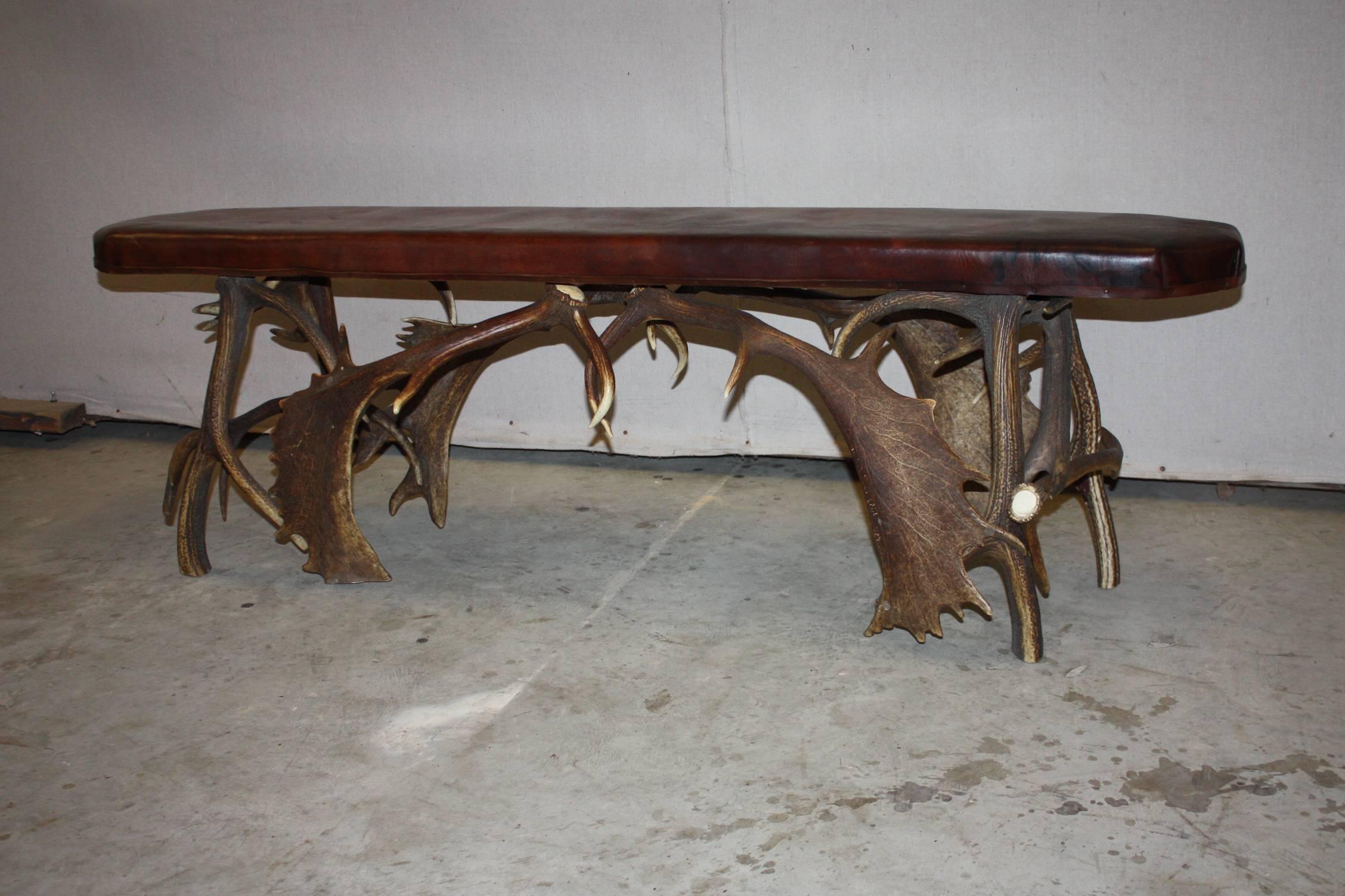 This is a really great looking leather topped bench with a base made of fallow deer antlers.  It was purchased in England.  It has a very good look.