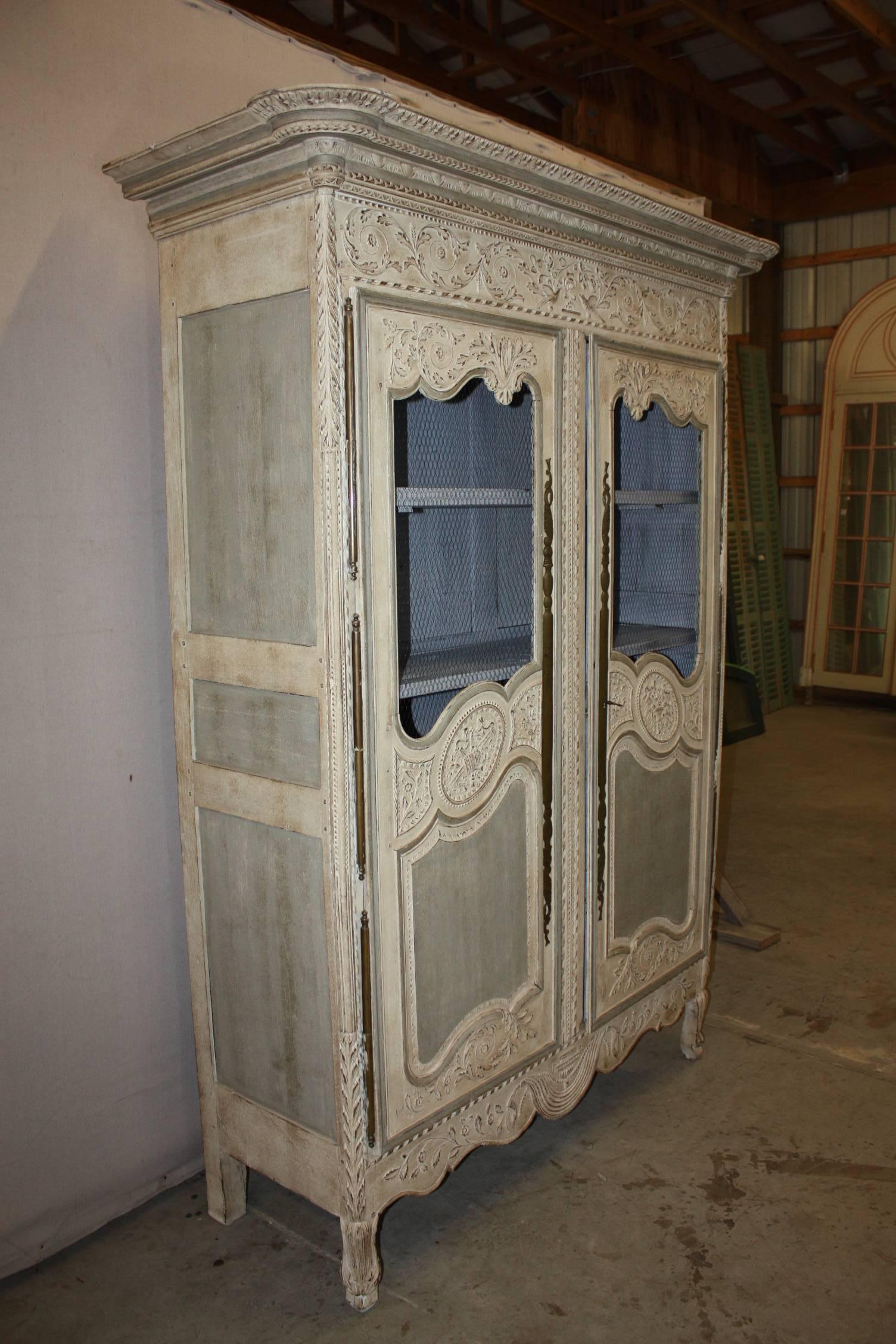 19th century French hand-carved and painted Louis XV armoire with flowers and bows with three shelves, two interior drawers. This piece has its original hand-forged lock and outer door hinges and one key.