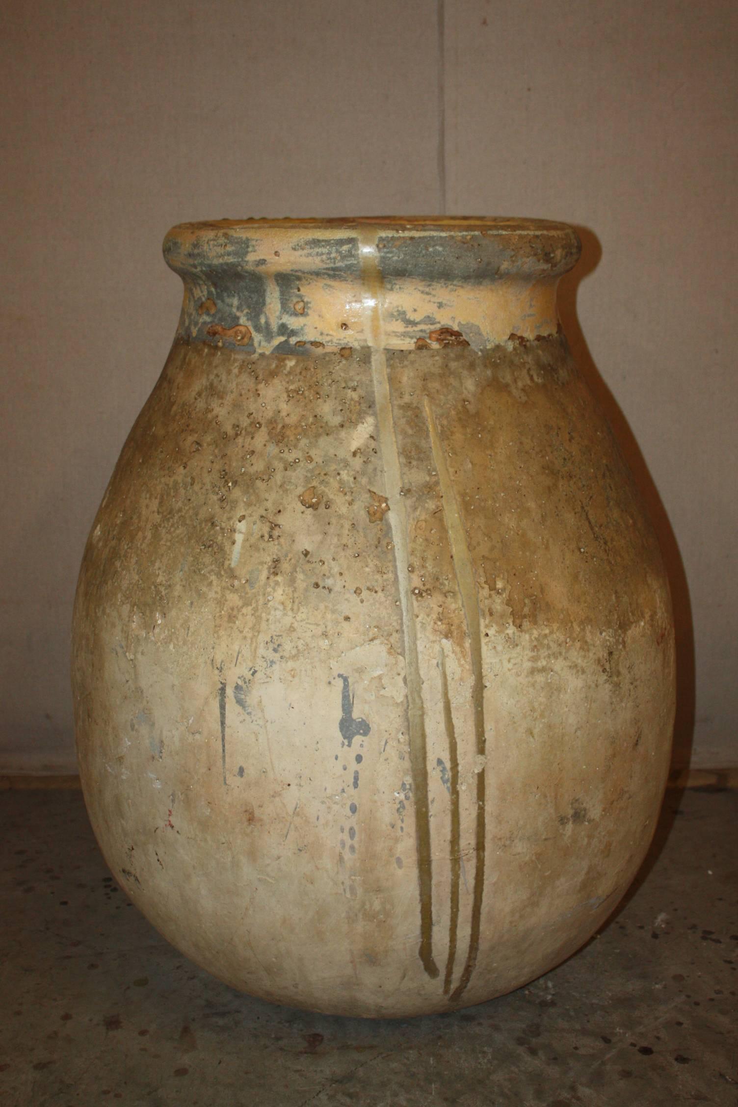 This is a great looking large French provincial olive jar from Biot, Provence. It dates to the early 1800s. It has a very attractive bulbous shape. It also has 