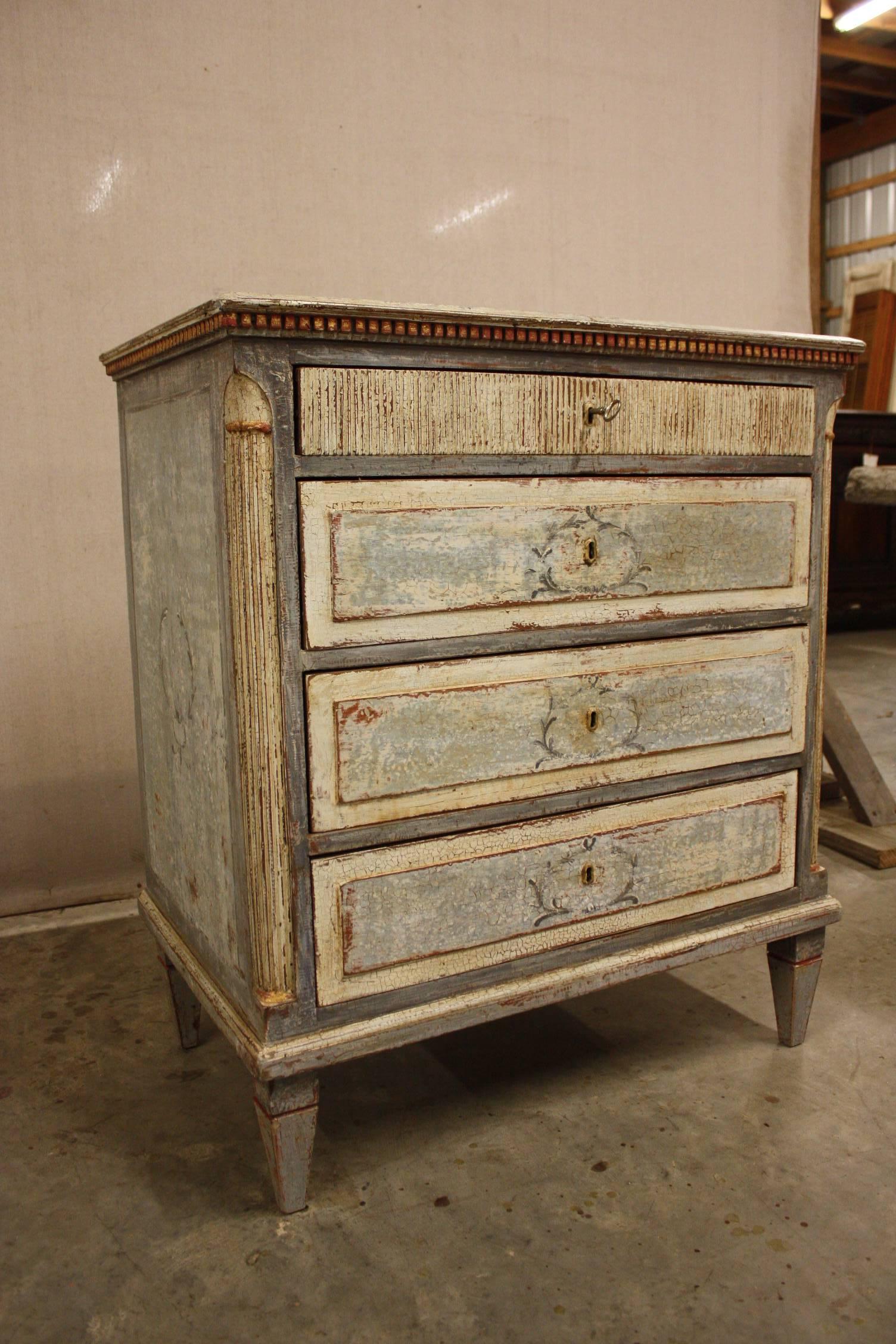 Small chest with four drawers, painted and has a dental molding around the top.