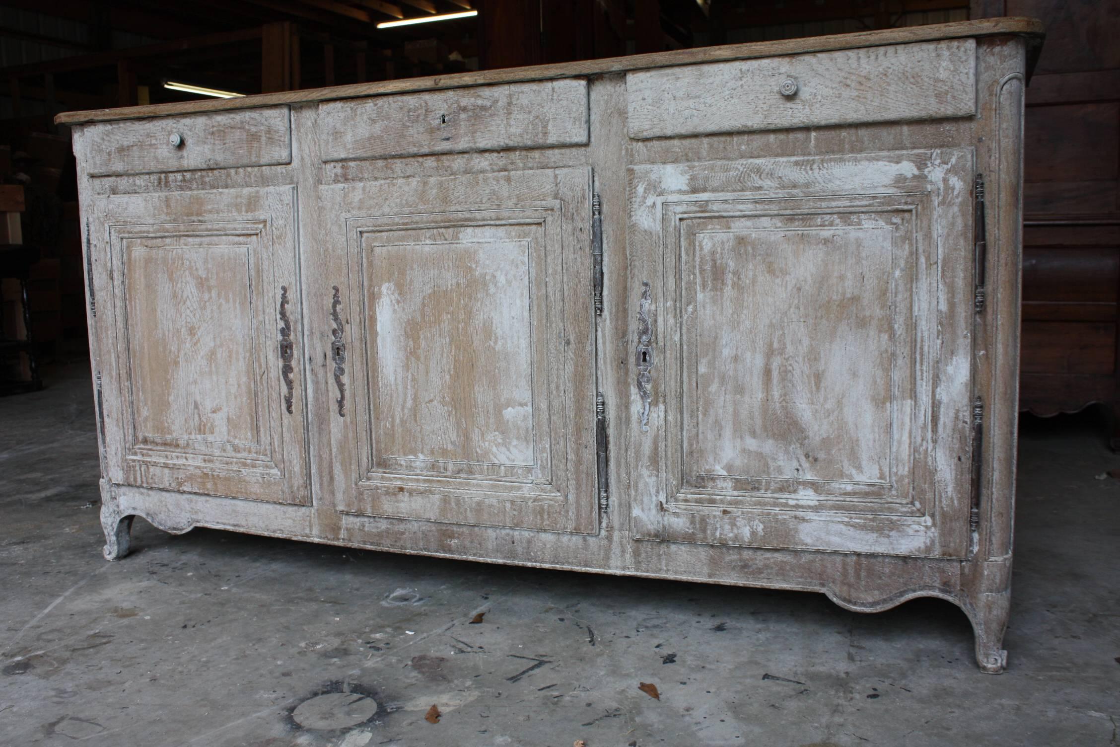 White-washed 19th century French enfilade with three doors and three drawers.