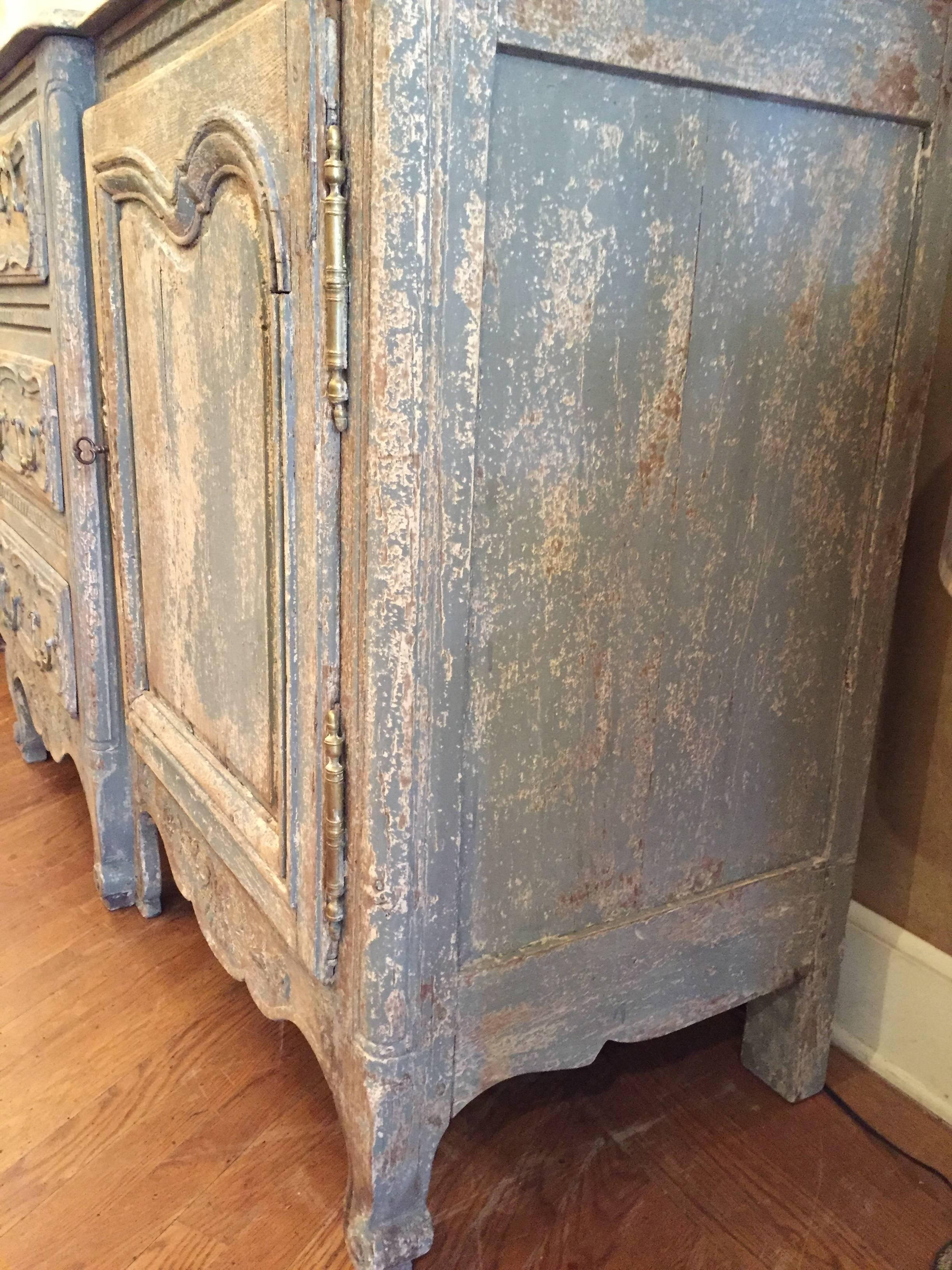 A large antique French, Louis XV style painted oak buffet/enfilade having two-doors and three center drawers, circa 1850. Beautiful patina in the original painted piece with a bleached top.
