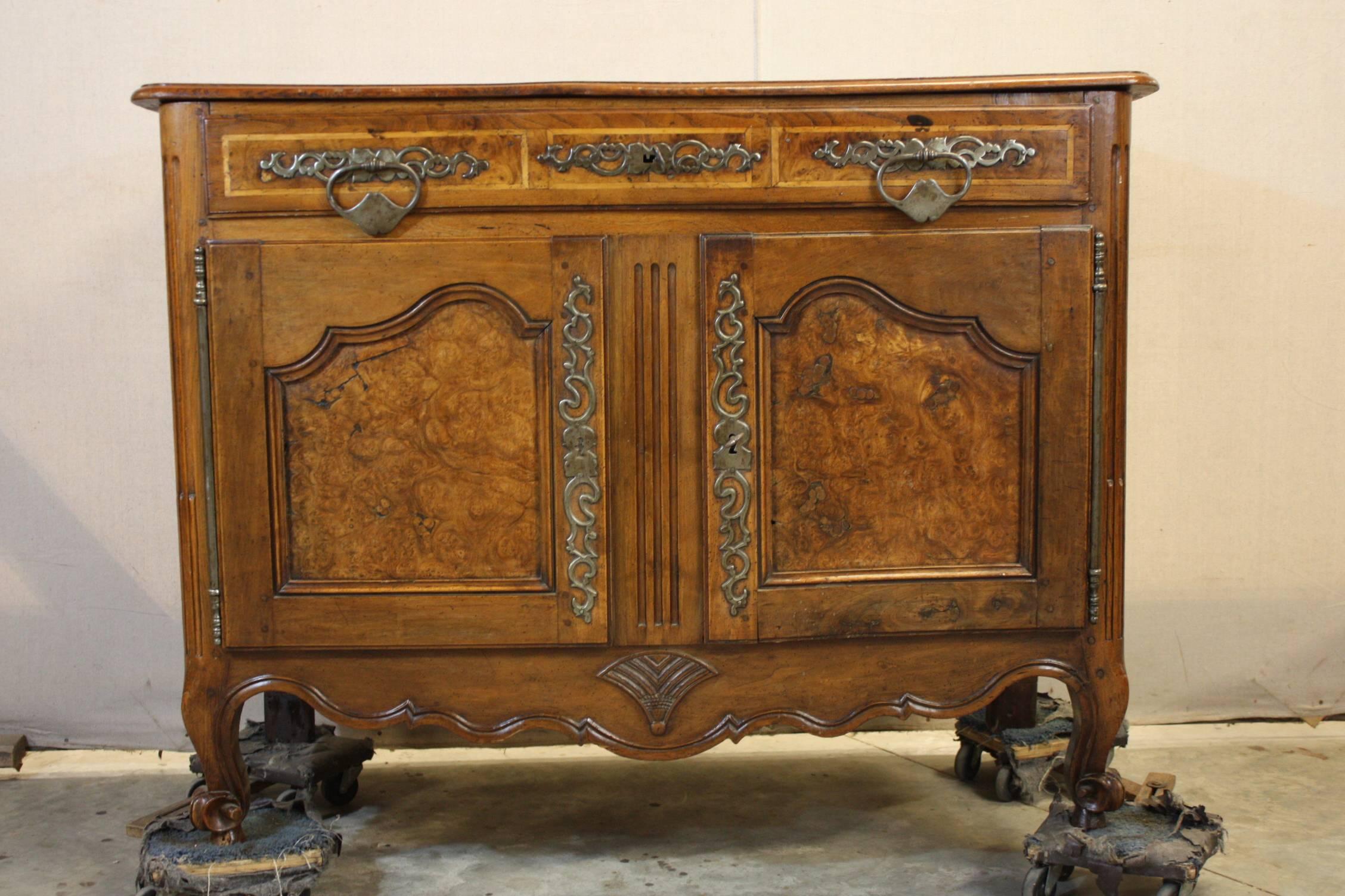 This is an extremely beautiful French walnut two door buffet I purchased in France. The carvings are really fine. It is in excellent condition for an 18th century piece. There is one shelf and two drawers. The patina is very nice.