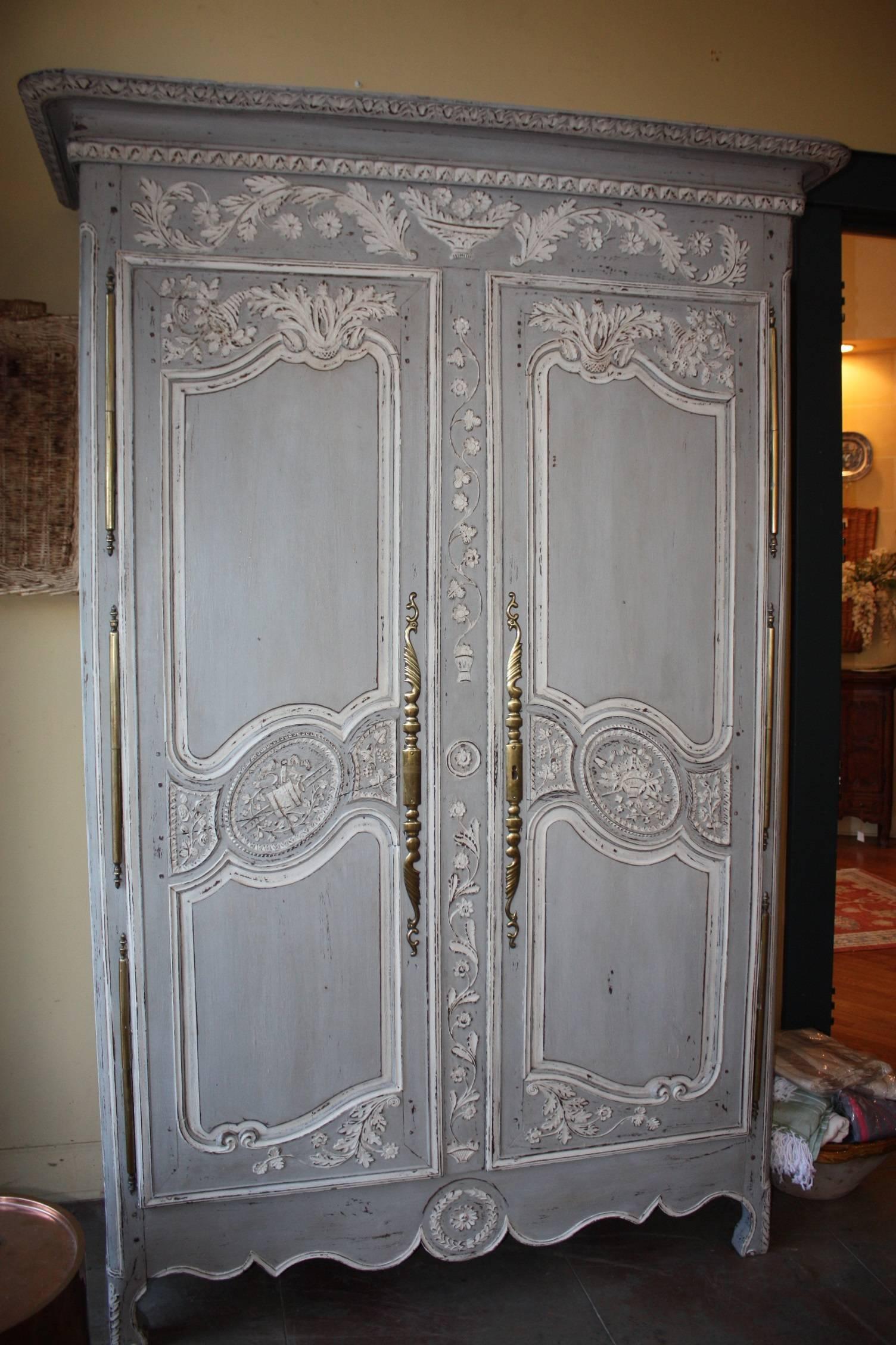 Antique French period Louis XV painted Amoire with detailed carvings, pewter hinges and hardware. Drawers and shelves are adjustable and could be moved around to fit a tv inside.