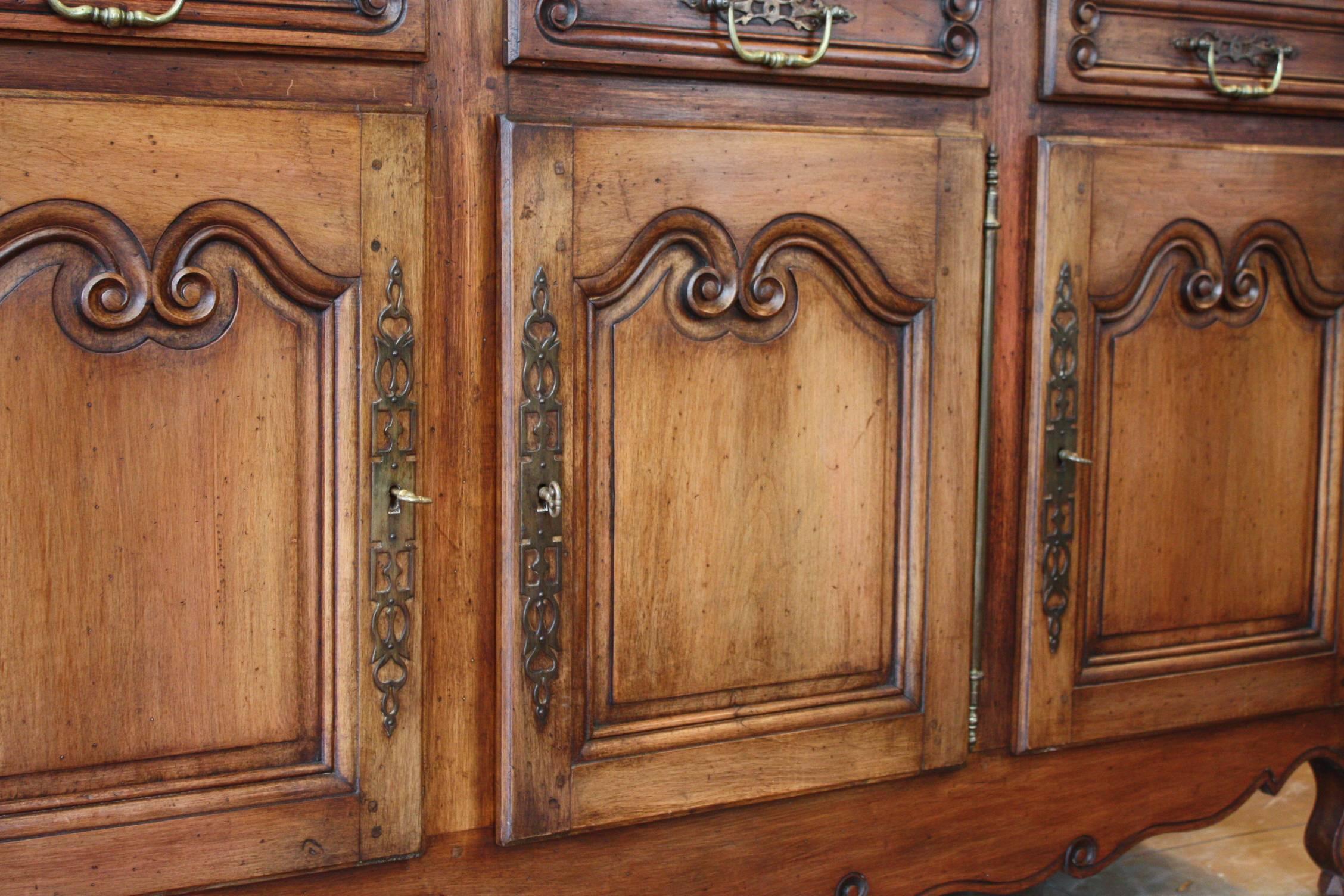 This exceptional Louis XV period enfilade features three panelled doors and three drawers. Perfect for a dining room setting. This piece also has its four original hand-forged locks, with working keys. A piece of history, both beautiful and