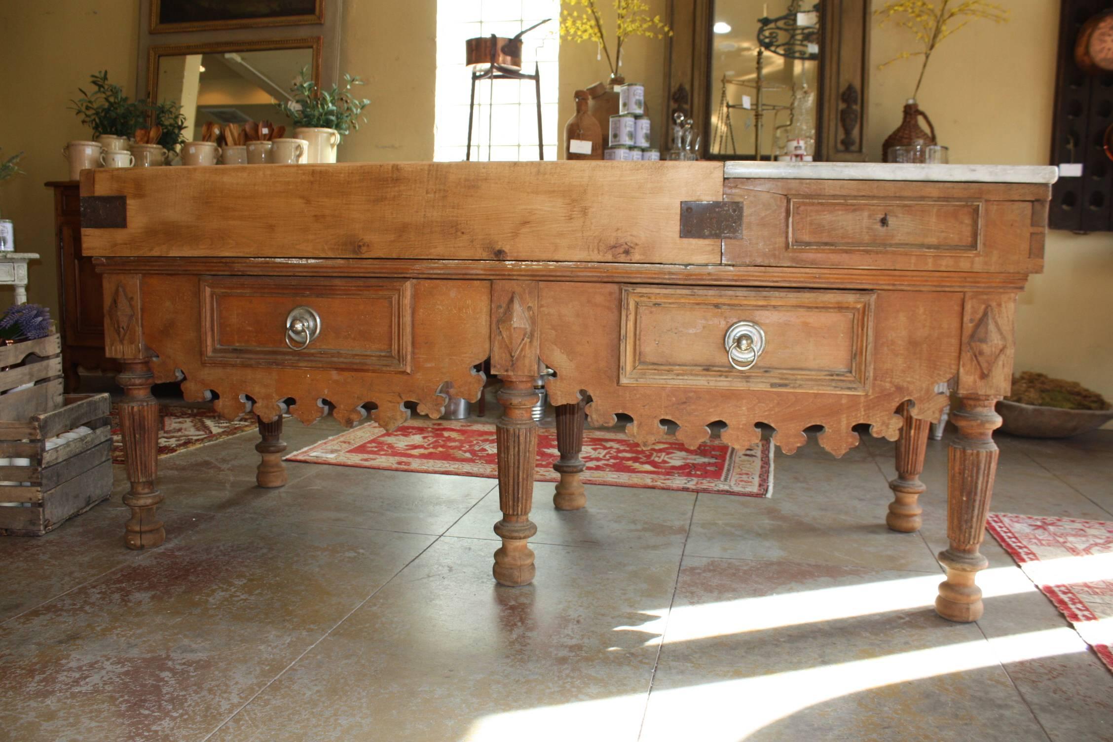 Beautiful and large 19th century butcher block from France. This would make an excellent kitchen island.  The butcher block with knife slot and marble is raised on a base, comprising two drawers with brass ring pulls and molded frames and an