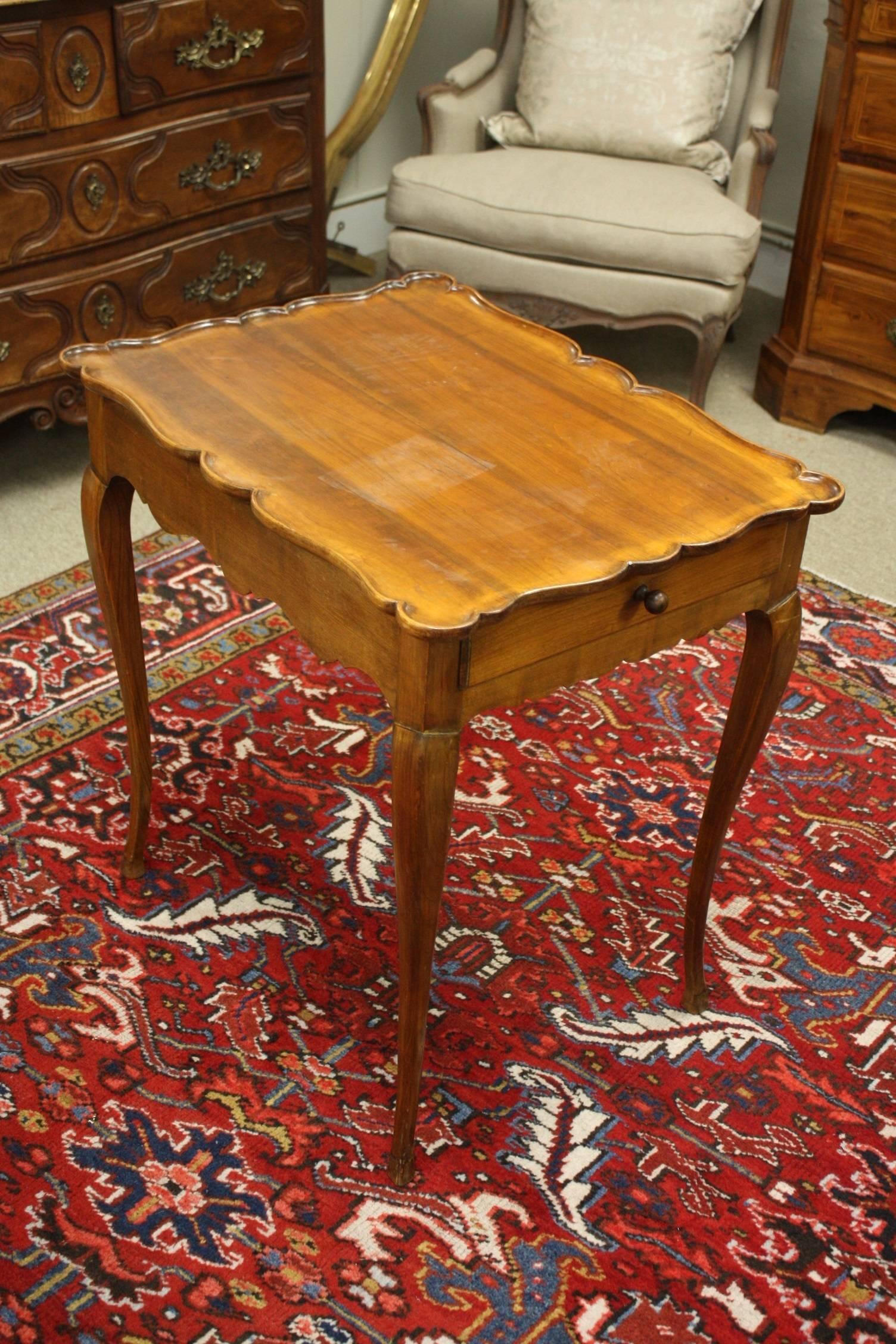 Walnut French side table with cabriole legs, hoof foot and a drawer on both ends.