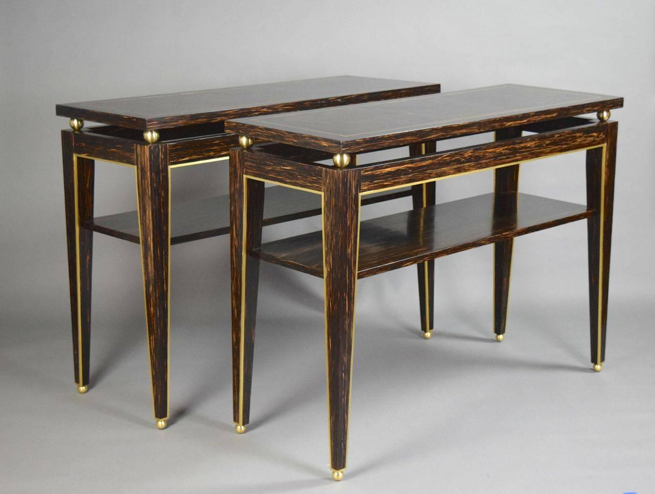 Each table has a rectangular parquetry top supported by spheres. The conforming apron leads to four square tapering legs fitted with a lower shelf. Of recent manufacture.