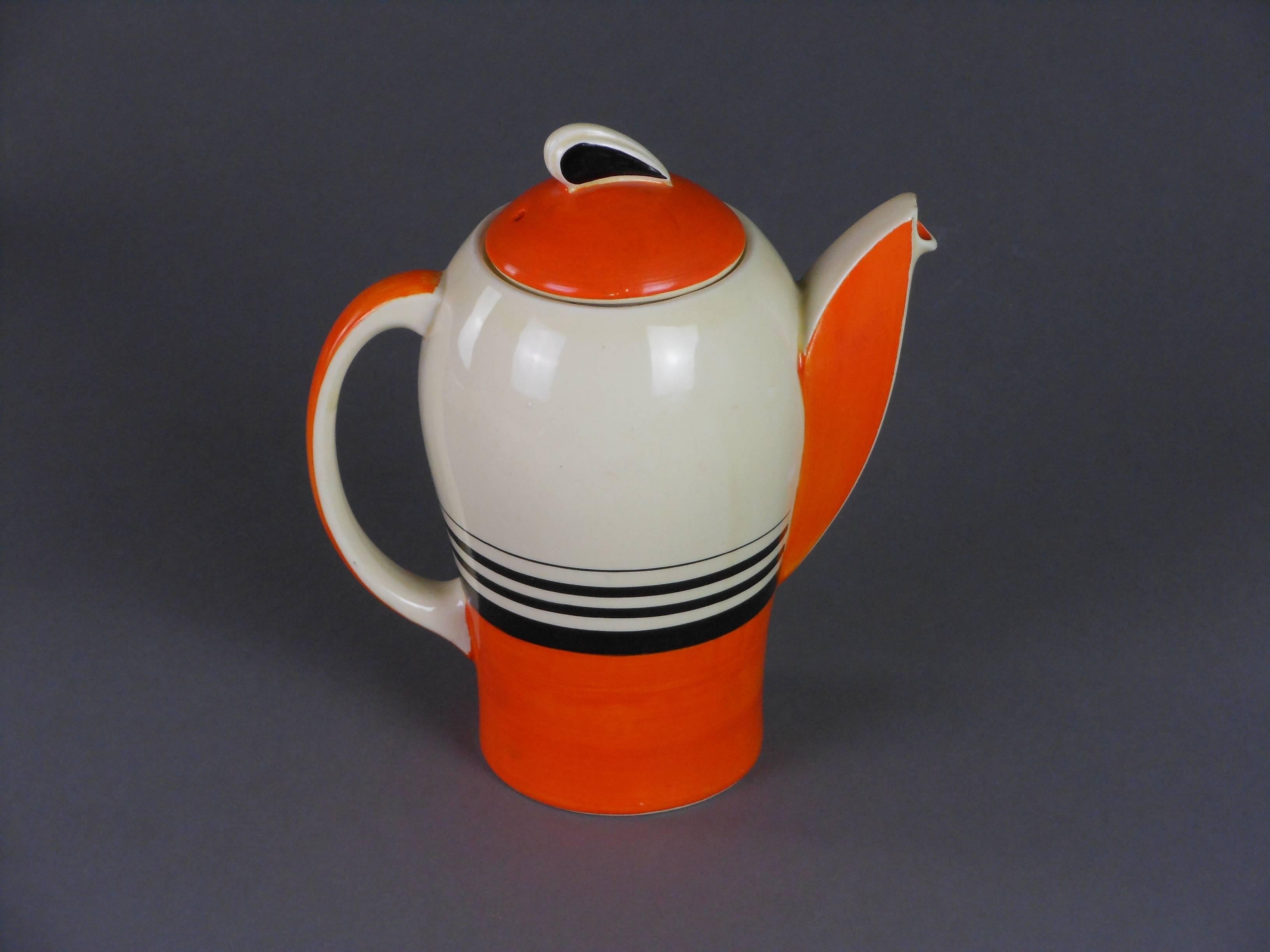 Susie Cooper designed this wonderful "Tango" coffee set design in 1933. This set comprises a coffee pot, creamer and sugar bowl, five cups and saucers and a pair of candlesticks.
Signed: A Susie Cooper Production, Crownworks, Burslem,