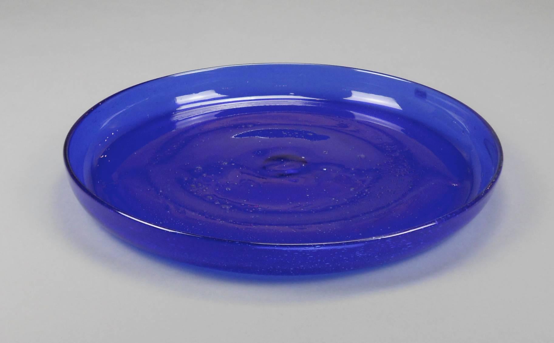 This large Swedish Modern circular cobalt blue glass dish has a lovely undulating surface. It has a Boda label and is inscribed on the underside H058/370.
Erik Höglund (1932-1998) was an innovative and successful glass designer for Boda,