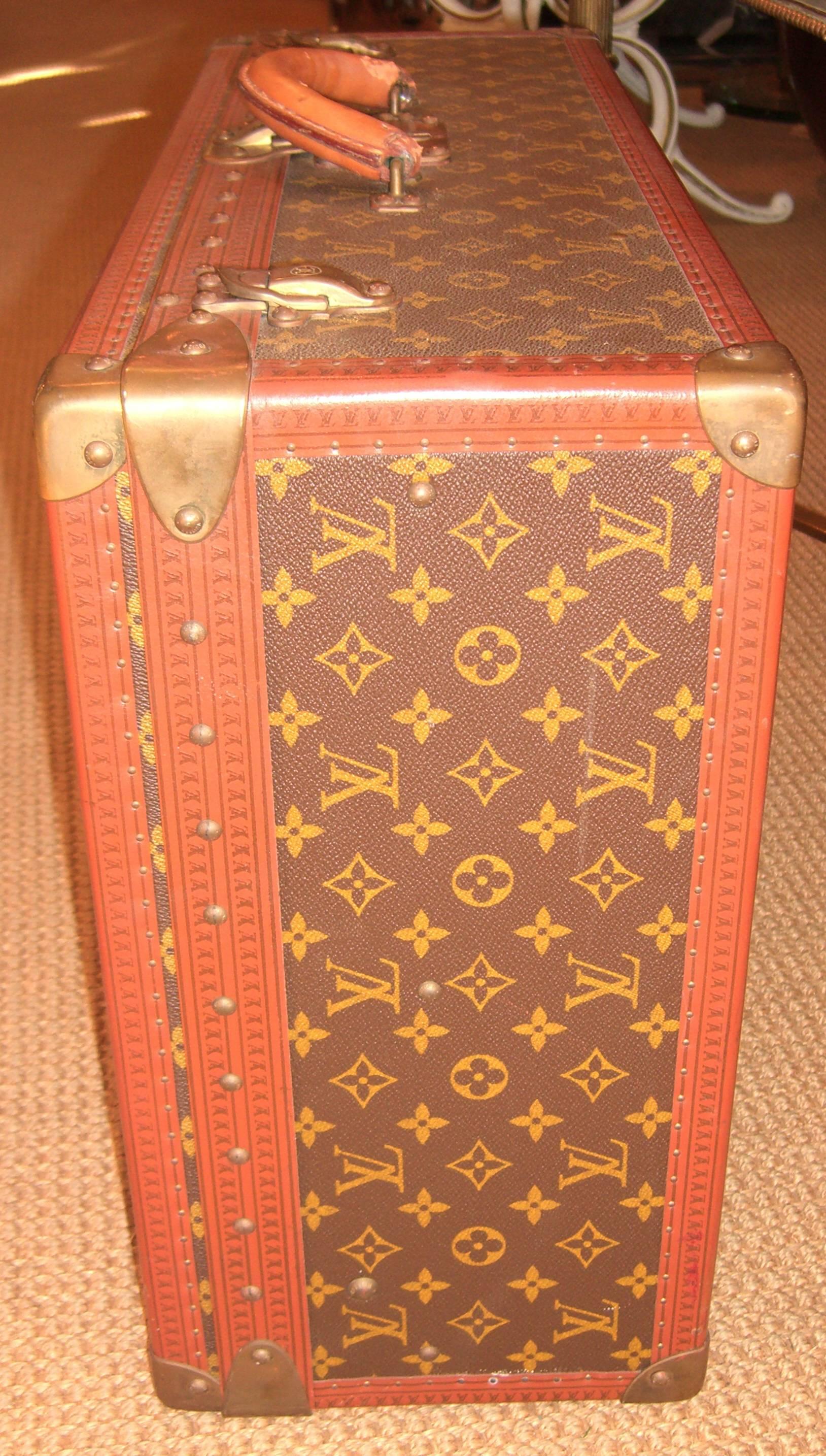 An authentic Louis Vuitton suitcase with removable tray.