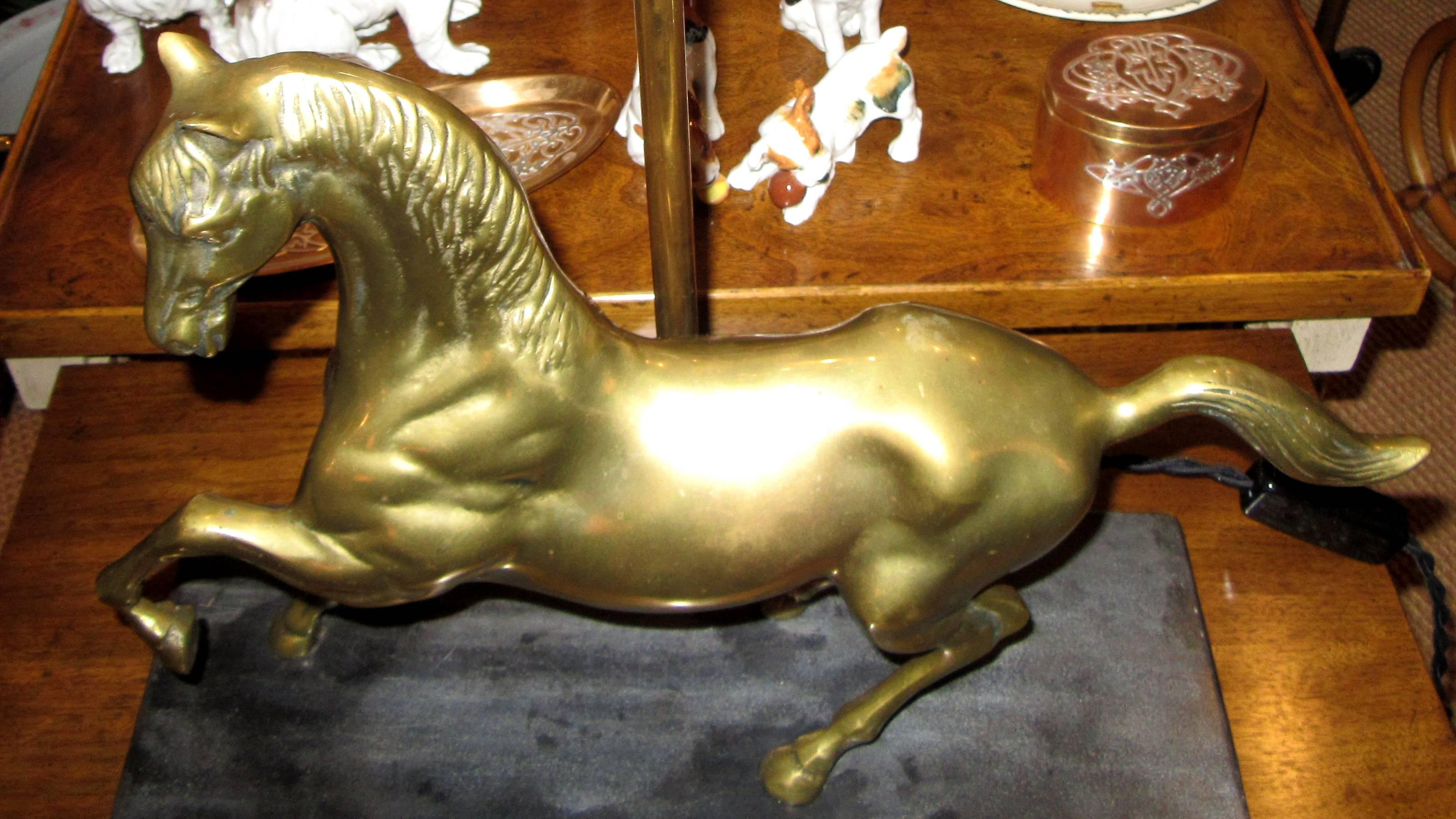 A solid brass horse in motion statue mounted on black stone. All wiring is new for the US.