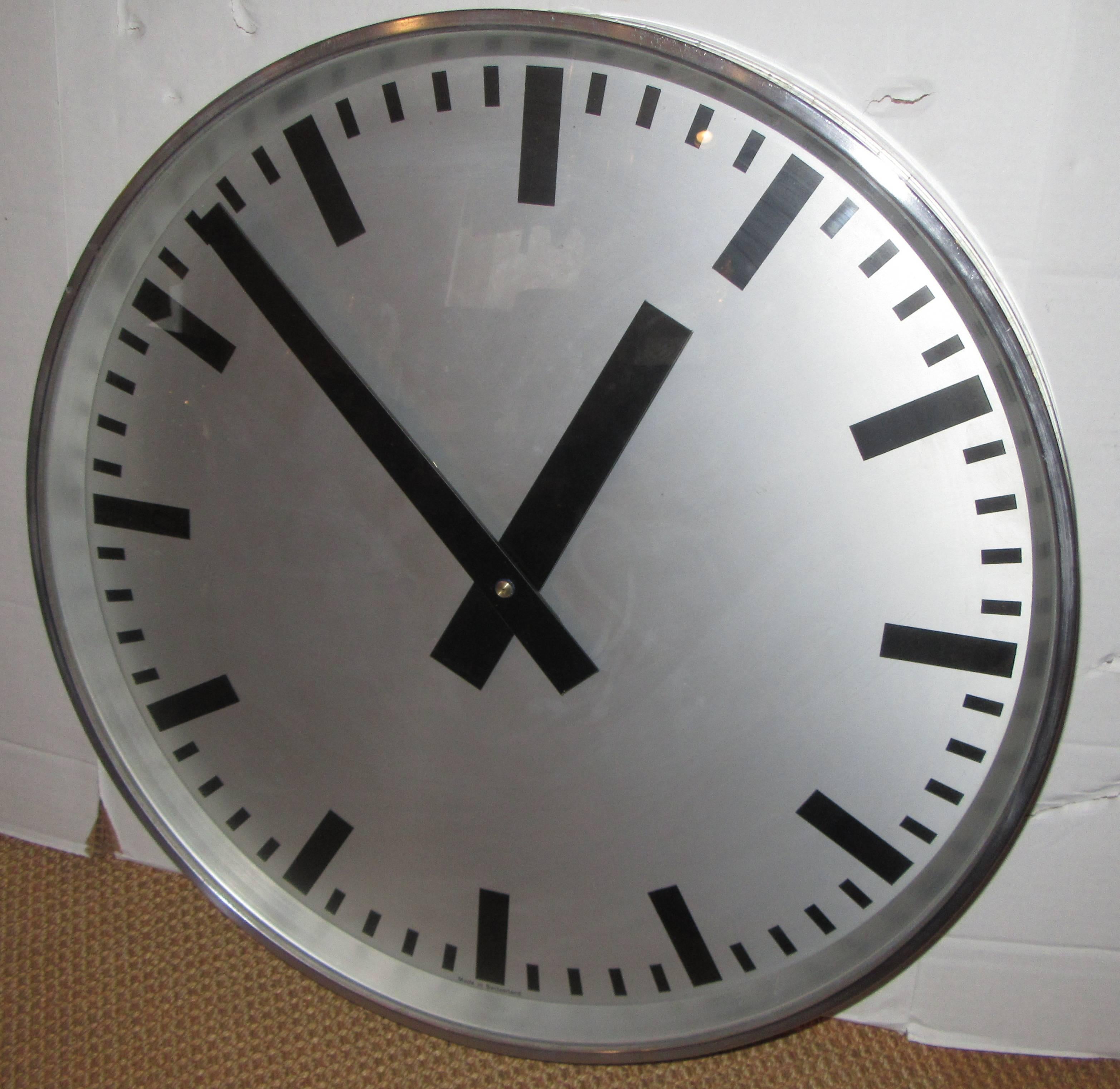 Once a factory or institutional slave clock this 1940s hanging wall clock has been converted to battery power. The frame is steel and the hands and number markings have a very cool industrial look.