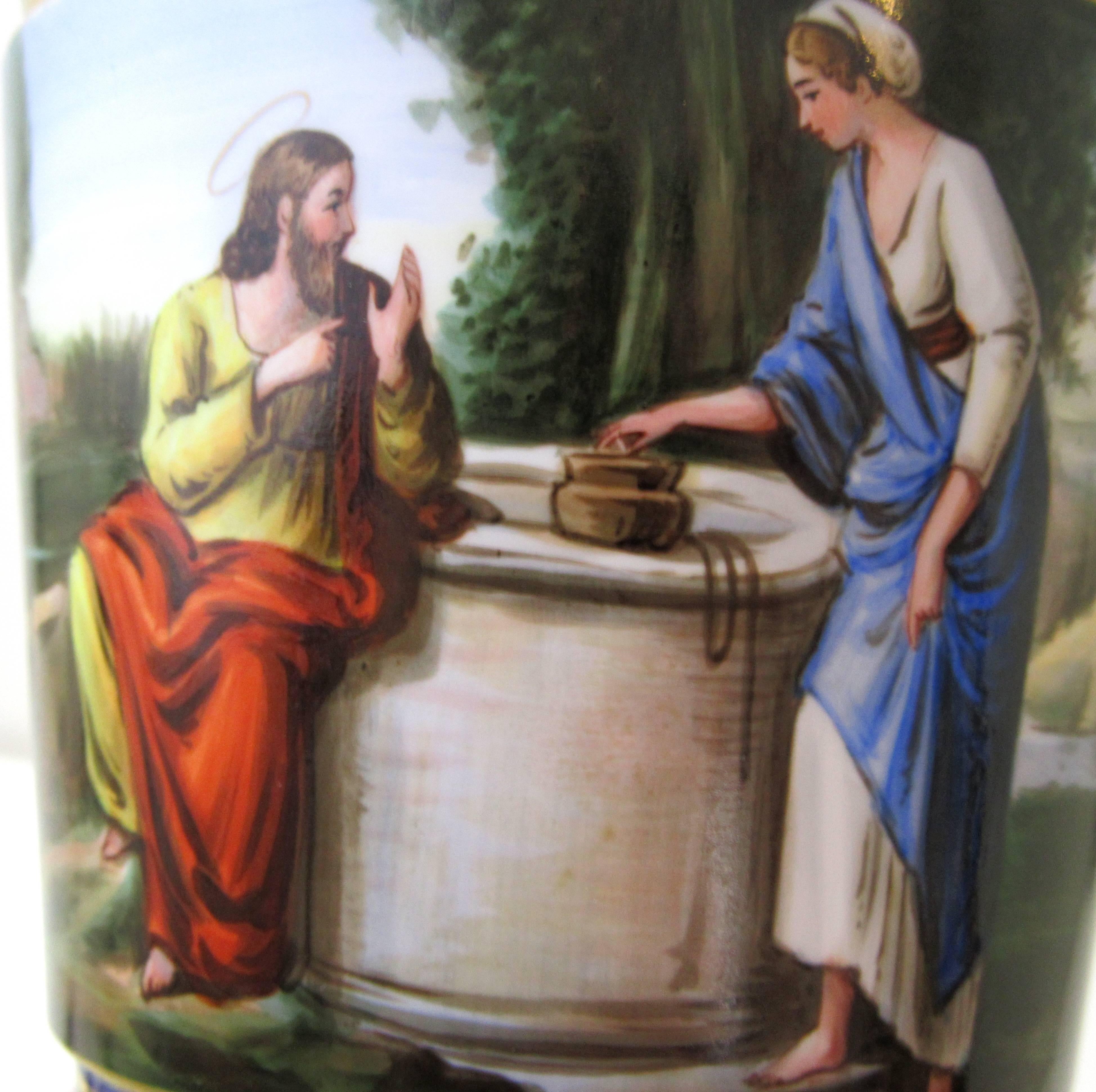 An art glass cut to cobalt tumbler hand-painted with a depiction of Jesus and the Samaritan Woman at the well.