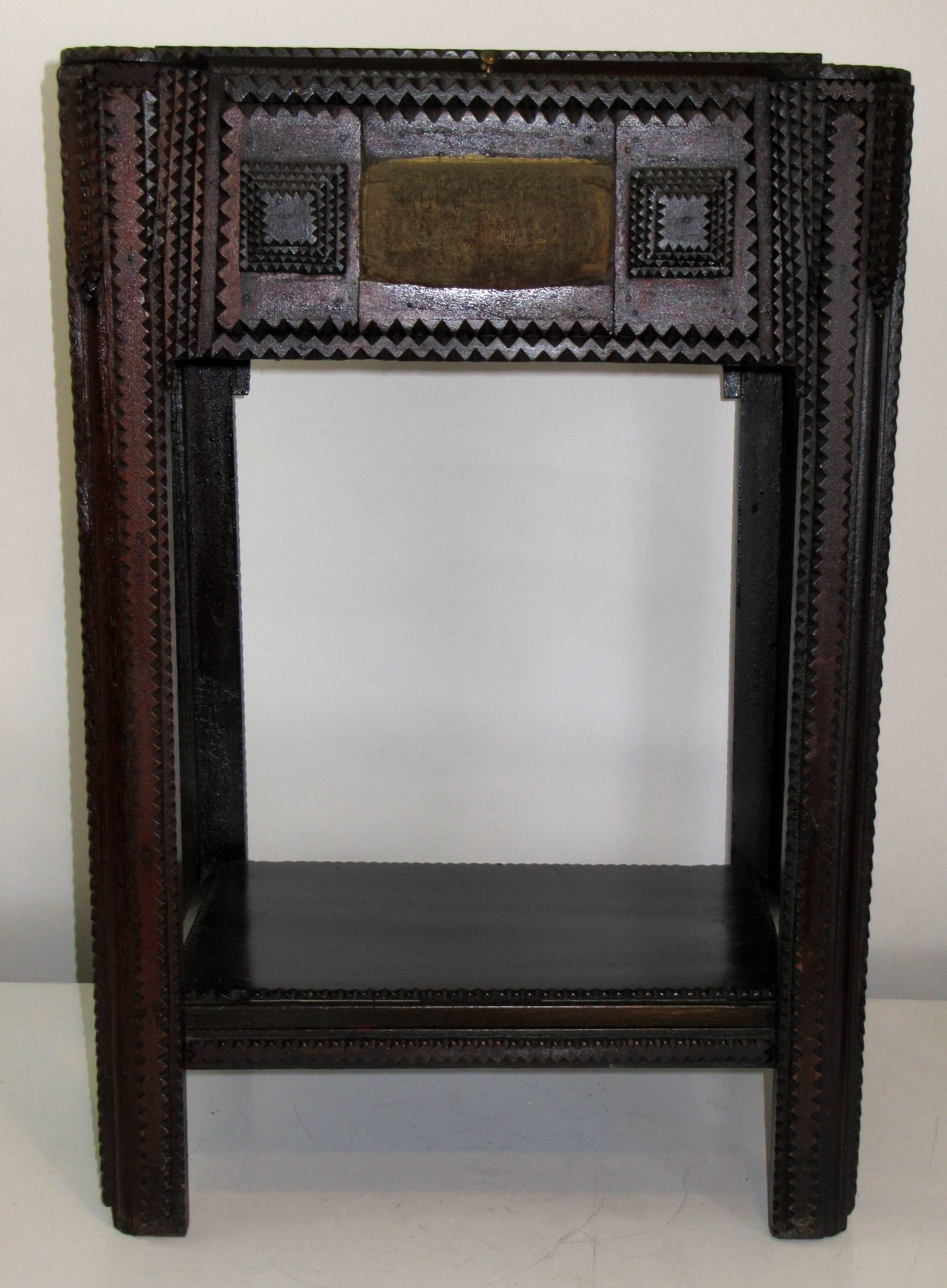 A hand-carved sewing box stand.