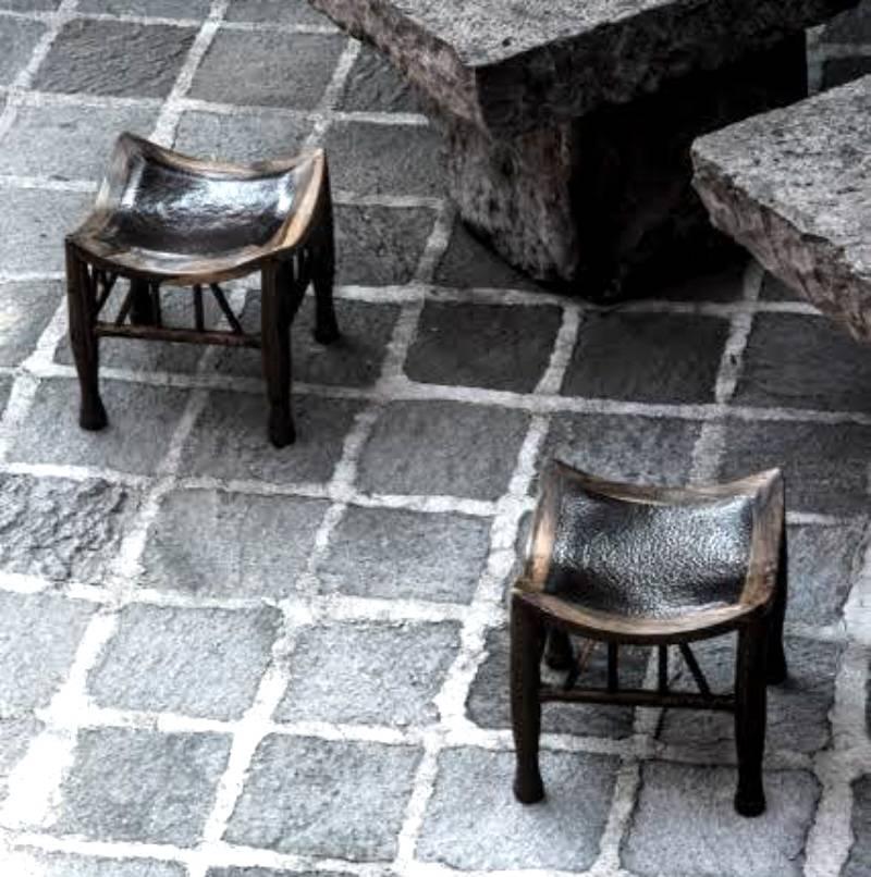 A pair of square tropical cueramo wood frame stools with seats of hammered copper. Designed by Miguel Angel Arregui and crafted by Mexican Artisans.