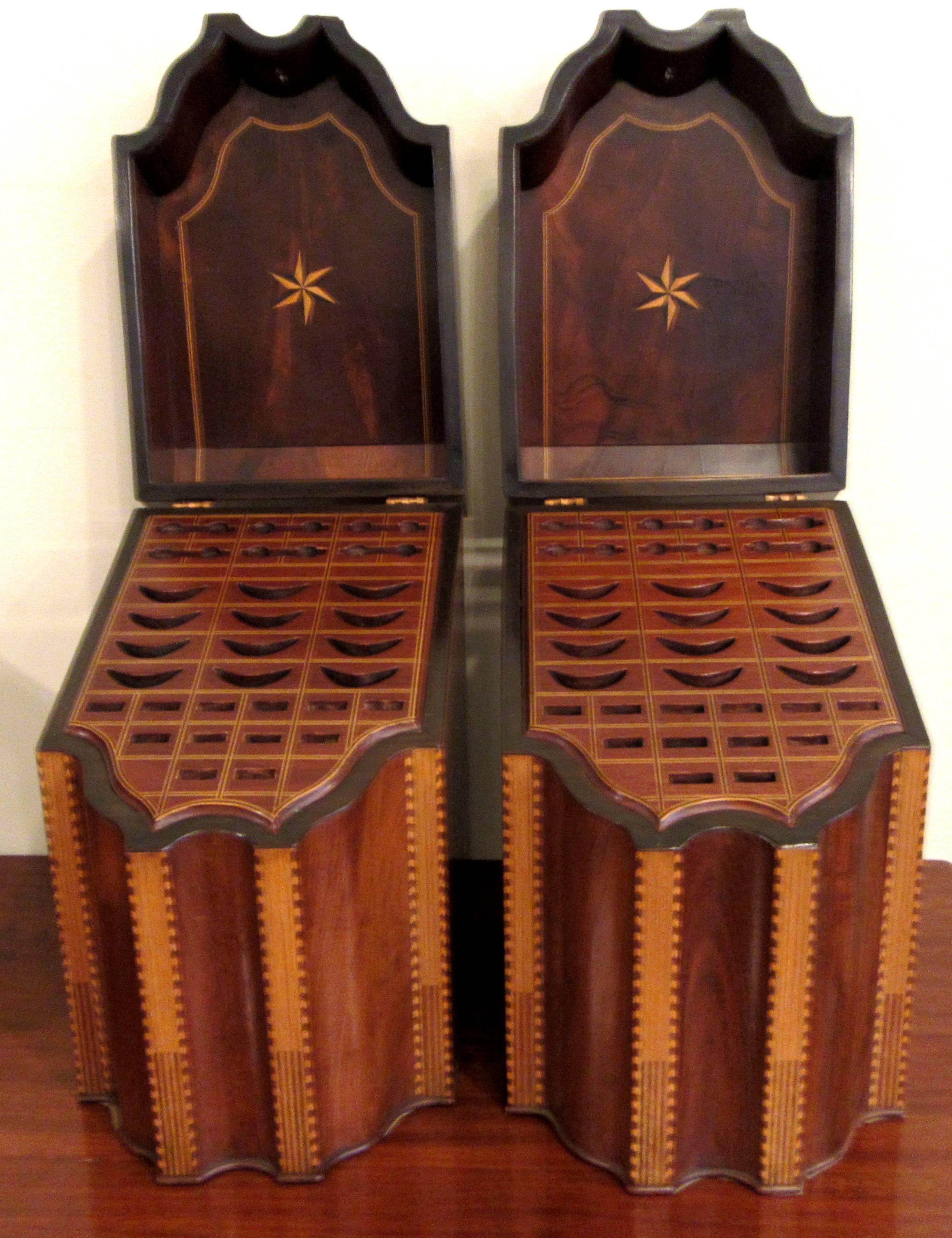 A stunning bookend pair of slant top, serpentine form knife / cutlery boxes with inserts. Inlaid banding, shell and star detail.