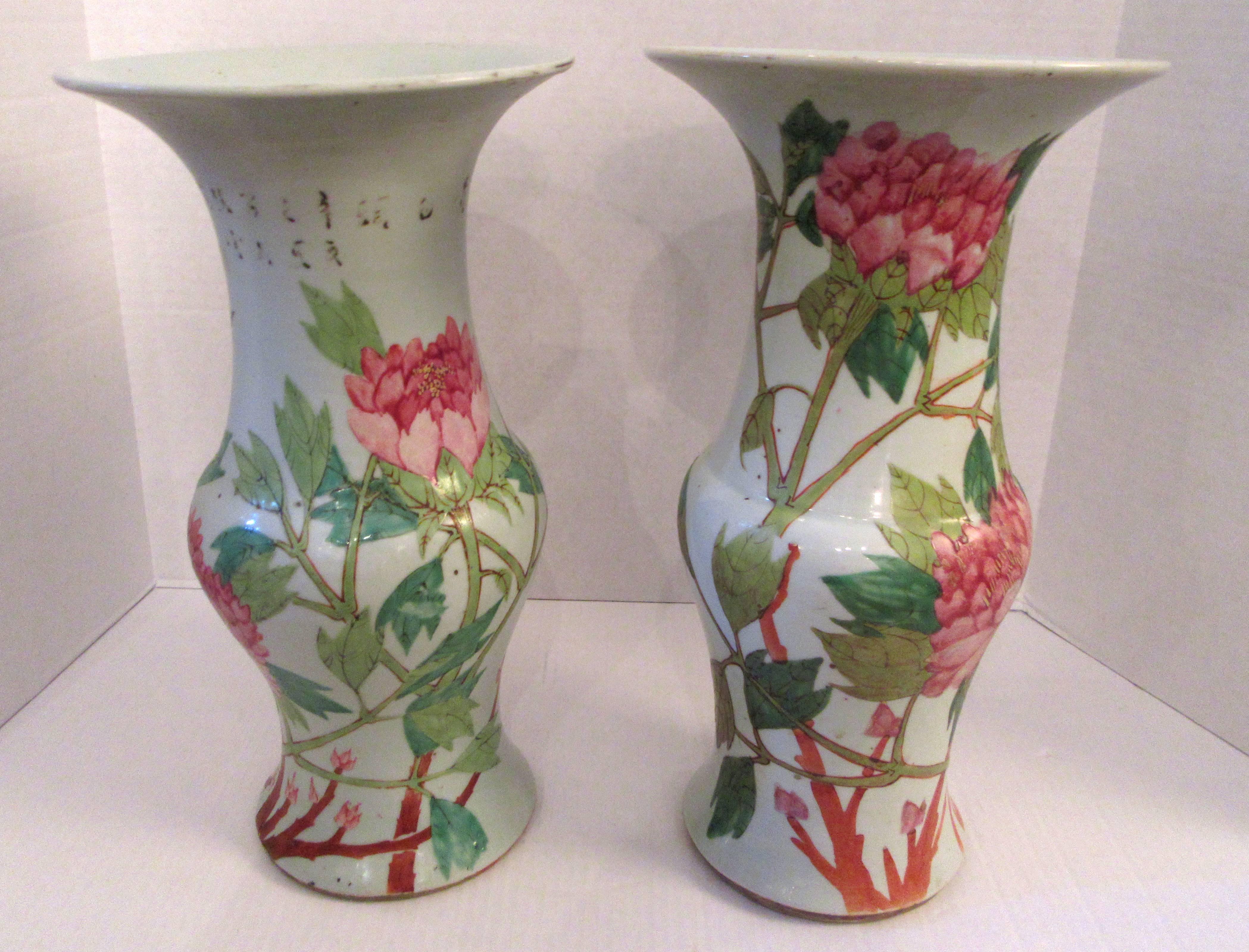 An associated pair of Chinese porcelain temple vase hand decorated with a pairs of Java rice finches on a branches. About the circumference large pink peony blossoms arise above leafy stems. The vase is considered to be from the Qing dynasty,