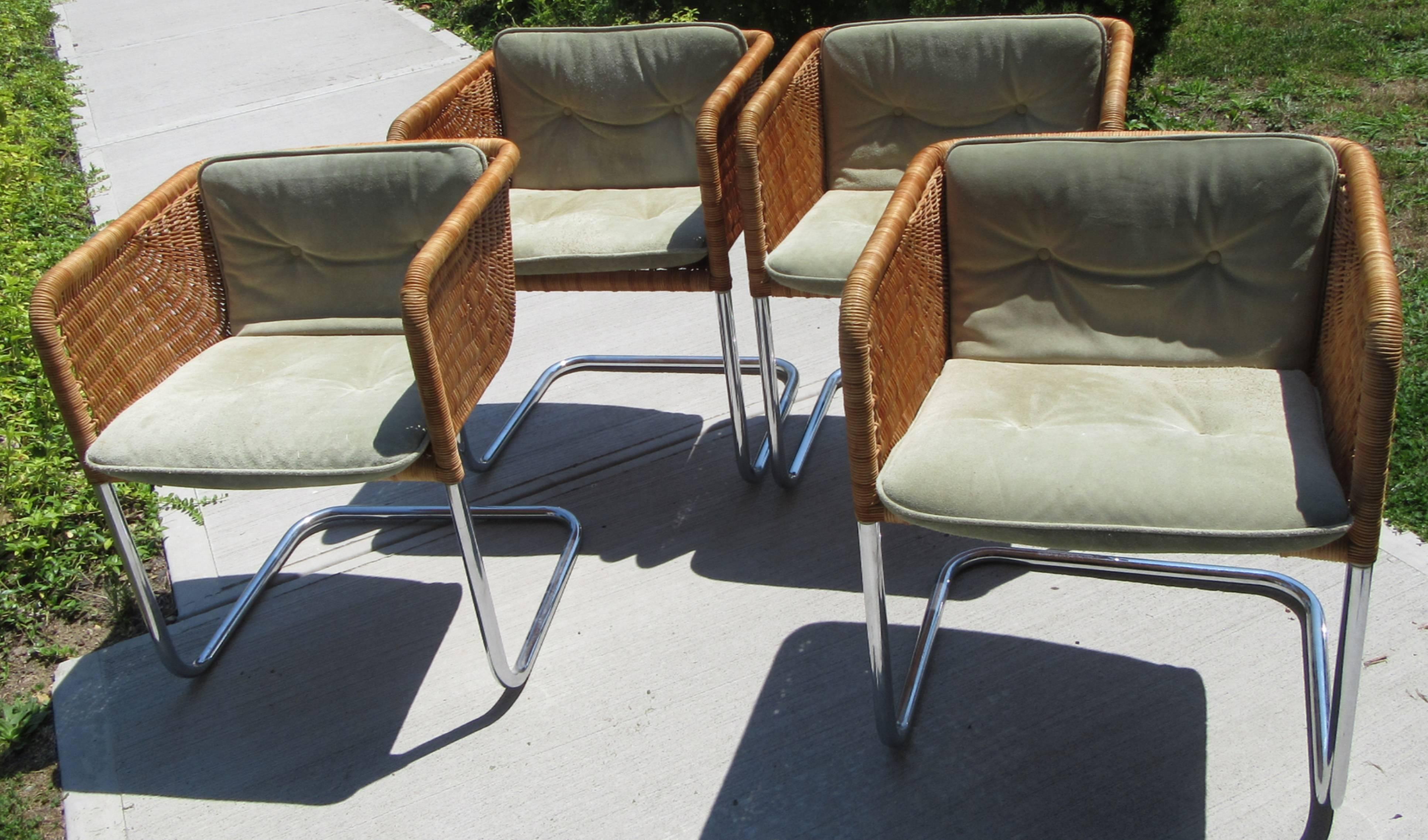 Set of four cantilevered dining chairs designed by Preban Fabricius & Jorgen Kastholm in Denmark and sold exclusively by Harvey Probber in the US. These feature a tubular chrome frame with a woven wicker seat 'basket'. The original cushions are