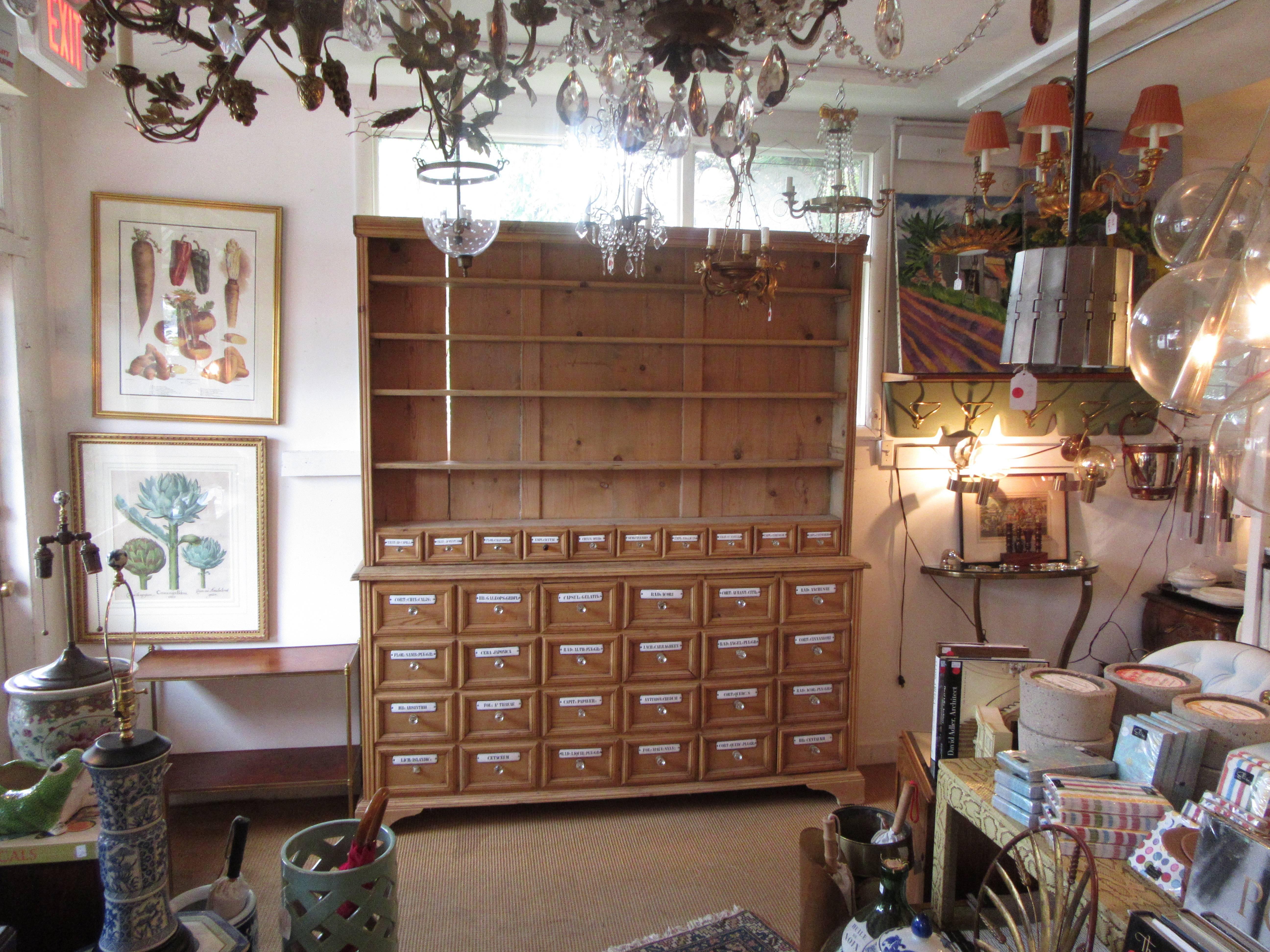 An apothecary cabinet with shelving made from reclaimed and new pine. Enamel labels and glass pulls are vintage.