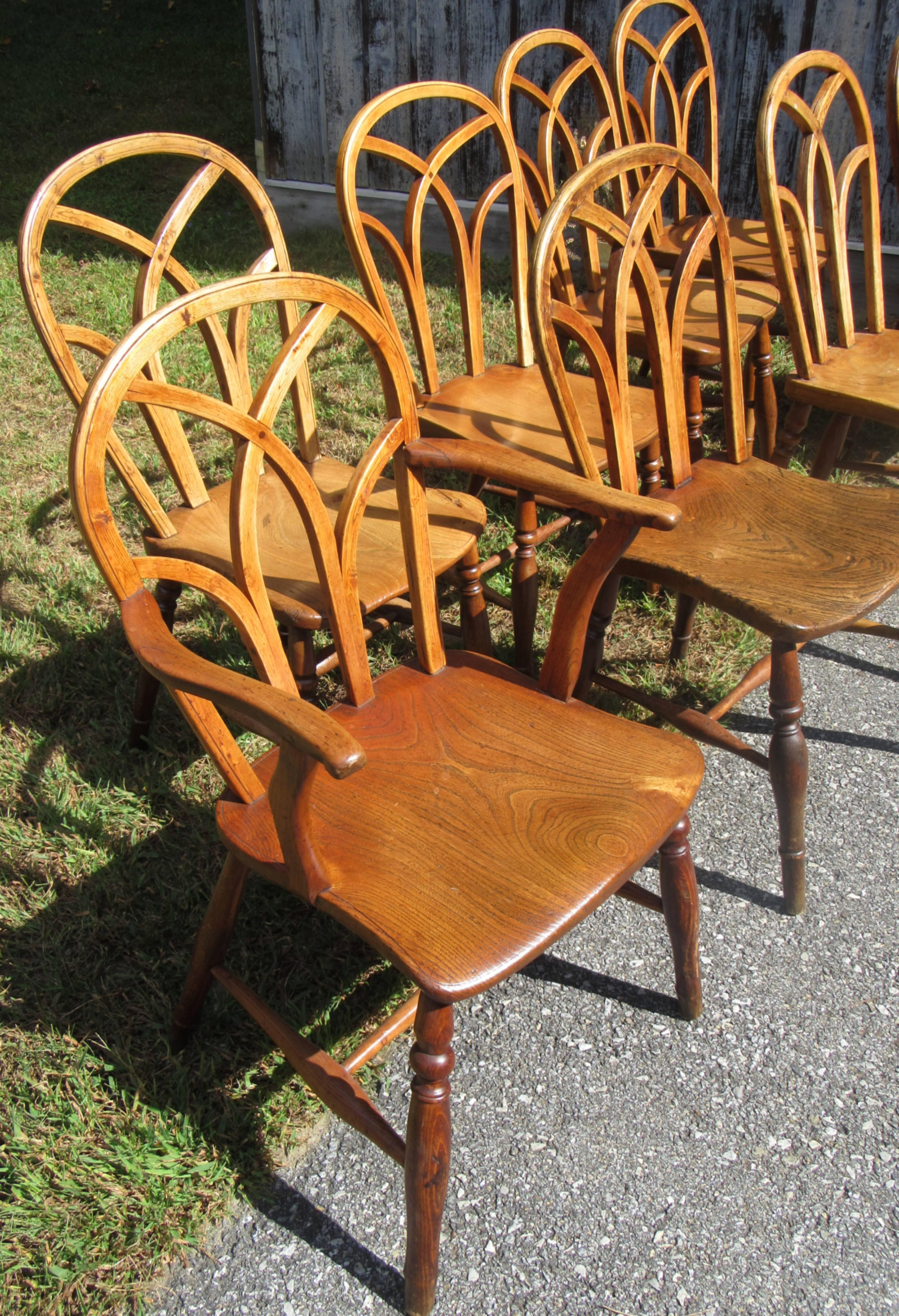 This Gothic style of Windsor chair are attributed to the Buckinghamshire area of the Thames Valley of England. The hoop backs and seats have a scribed edge line.
A set of six side chairs, and two armchairs, each with interlaced arched backs. One