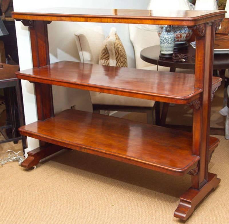 Elegant and practical three level server or étagère. Richly toned wood with hand carved scrollwork. Sits on casters.