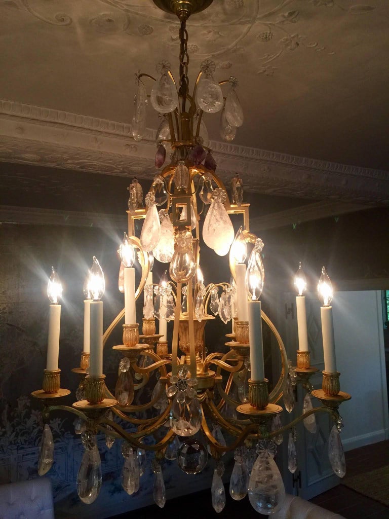 A twelve candelabra light gilded bronze multi level chandelier. Arms are adorned with large rock crystals, clear crystals, smoked crystals and the top with hanging natural form amethyst.
 