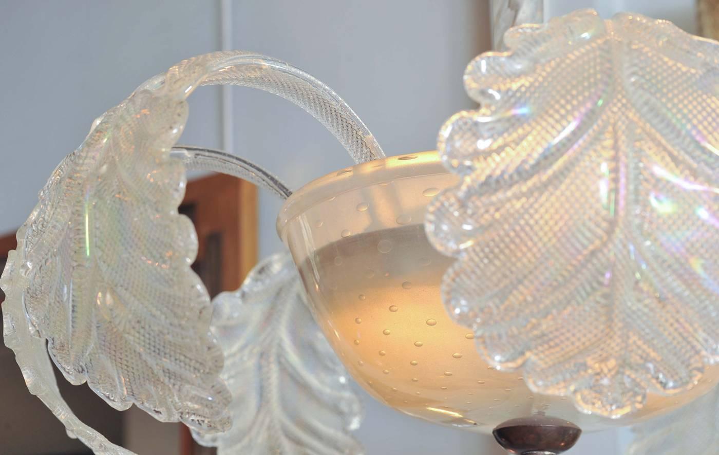 Delicate Murano glass chandelier with 'leaf' motifs springing from a glass basin, held by a 'rope twist' glass support, and finished off by an elegant glass droplet.