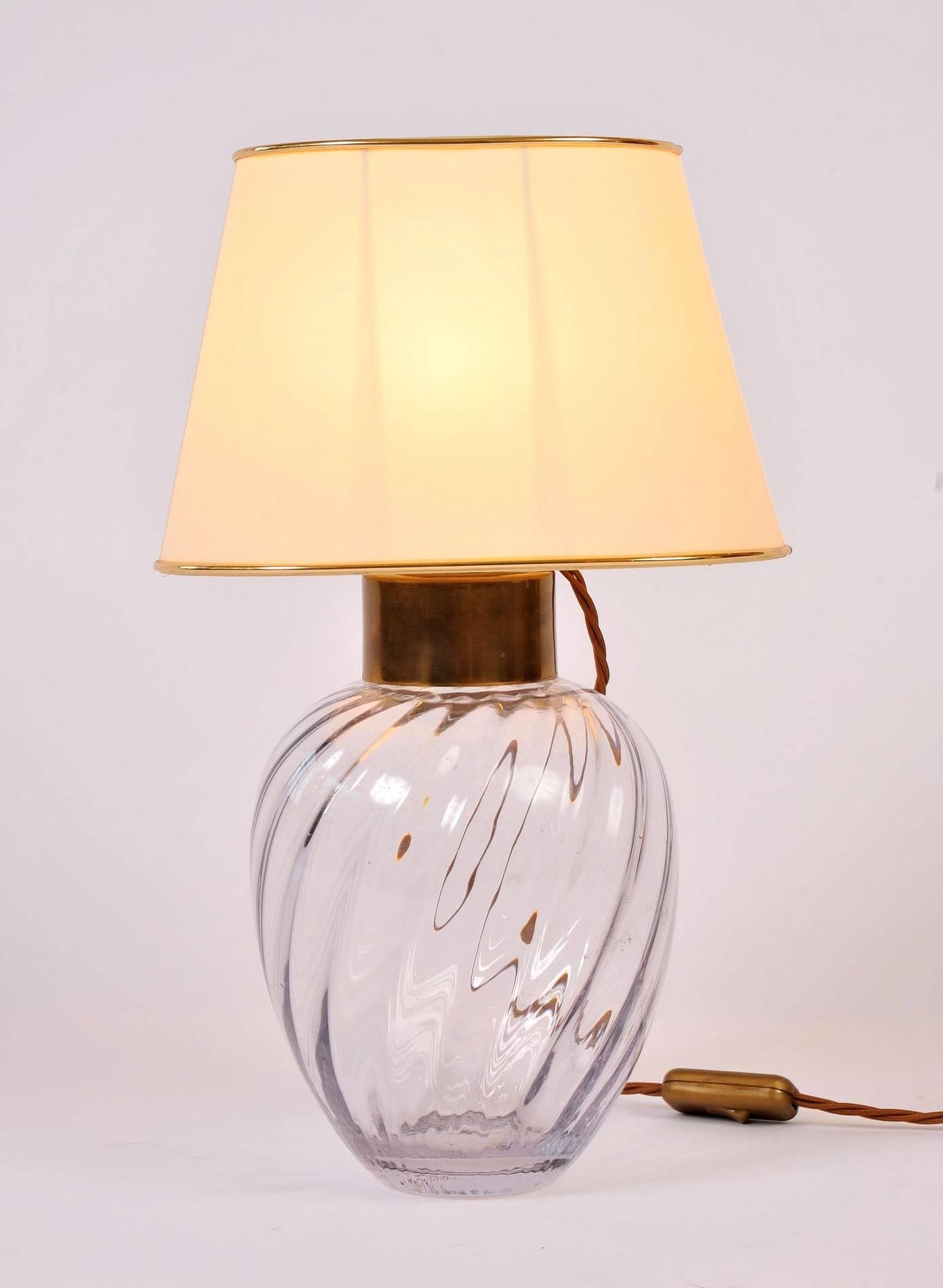 Boldly swirled glass lamps with generous brass fittings. Original parchment shades with gold trim.