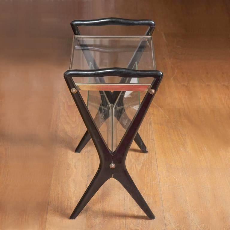 1950s Lacquered side table with 'x' frame sides supporting a rectangular glass top with brass sides and two diagonal etched glass panels forming a magazine rack – see detailed image of floral decoration on glass panels.