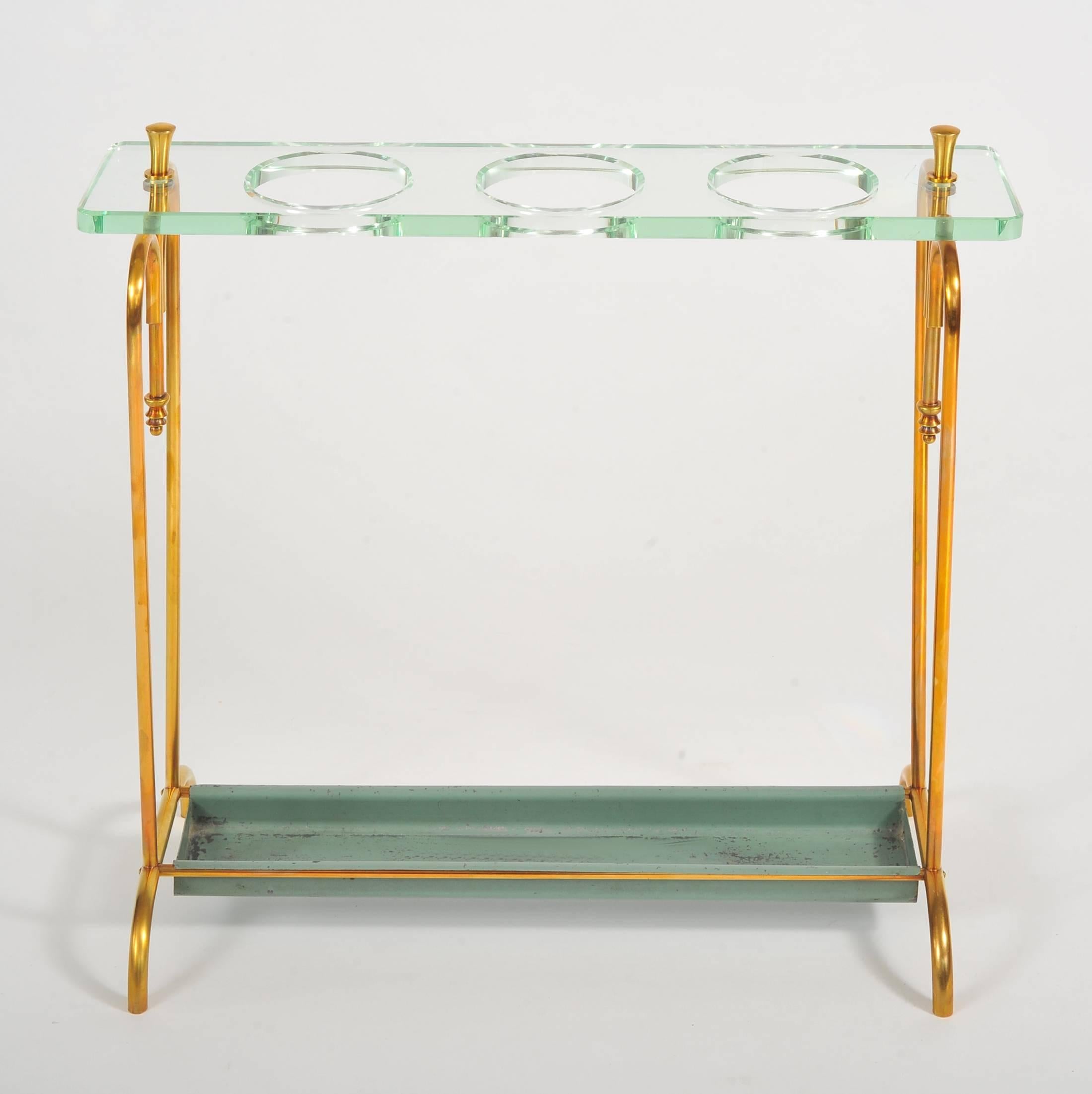 Functional and chic brass umbrella stand with thick glass shelf to hold multiple umbrellas. Green painted drip tray.