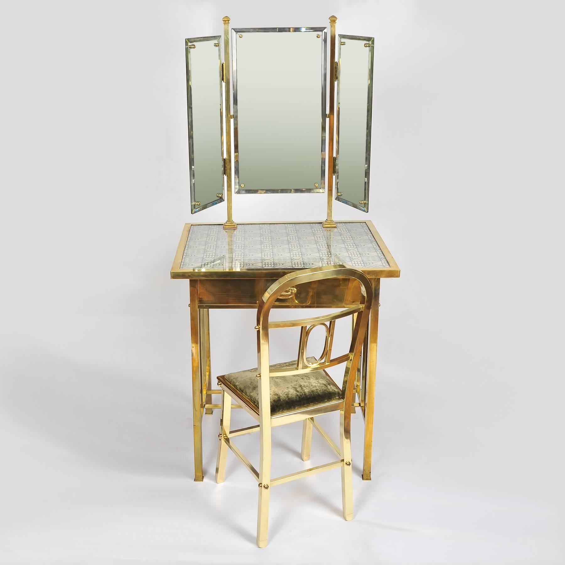 Wonderful brass dressing-table with matching chair, the table with integral triptych mirror and original 1950s embroidered patterned textile, the brass chair upholstered in grey-green velvet. Dressing table: 62.25
