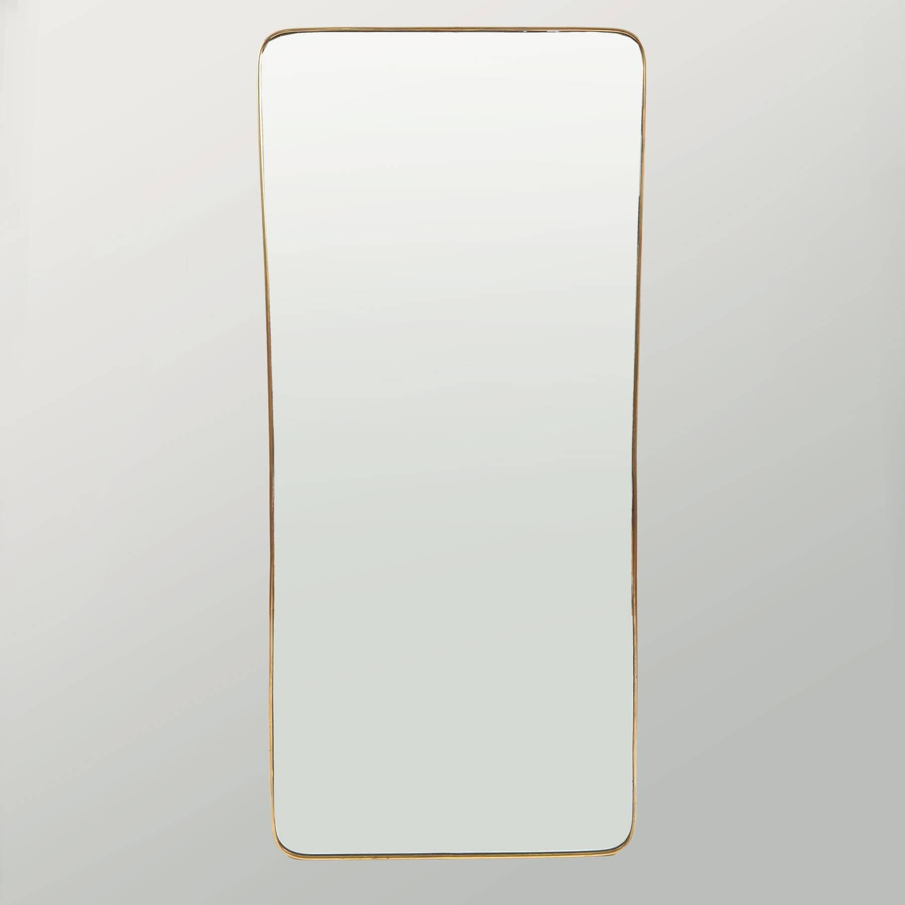 Tall Italian 1950s shaped mirror, with subtle narrowing in the middle. A thin brass frame surrounds the original mirror etched with a deep 3cm bevel.