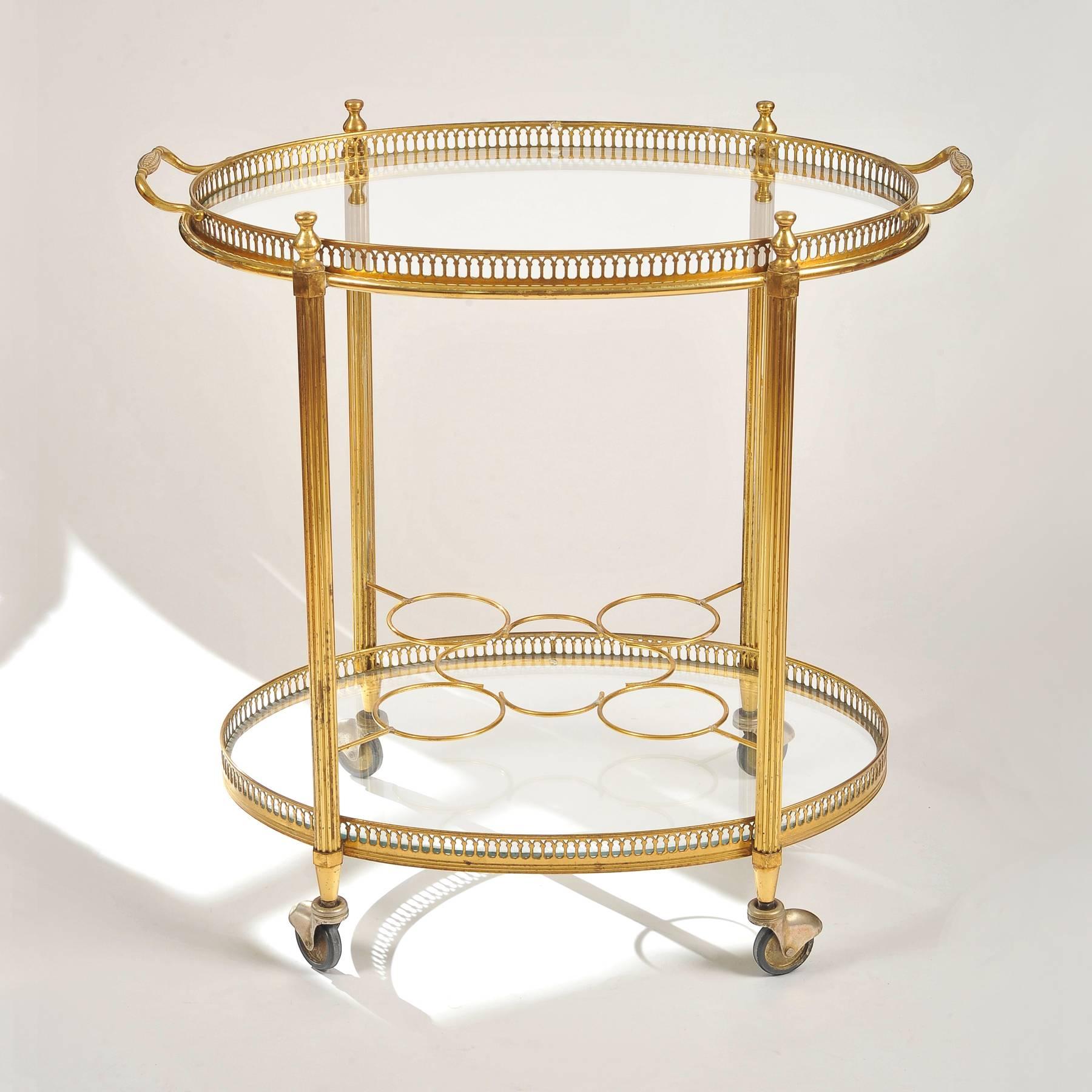 French two-tiered drinks trolley with compartments on lower tier for eight bottles, the upper top detachable forming an oval tray with two handles.