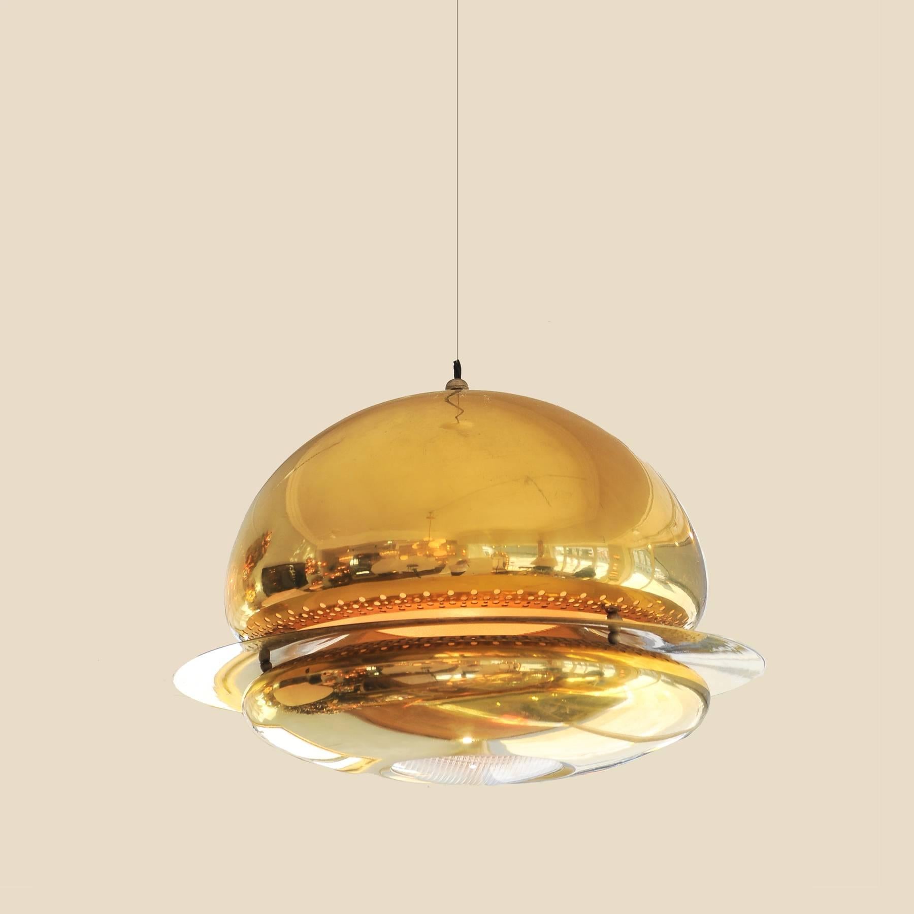 Impressive brass 'cosmic' chandelier comprising upper dome with floating decorative brass ring that allows for a band of light and interesting reflection. Brass base with textured glass section also exudes subtle mood light.