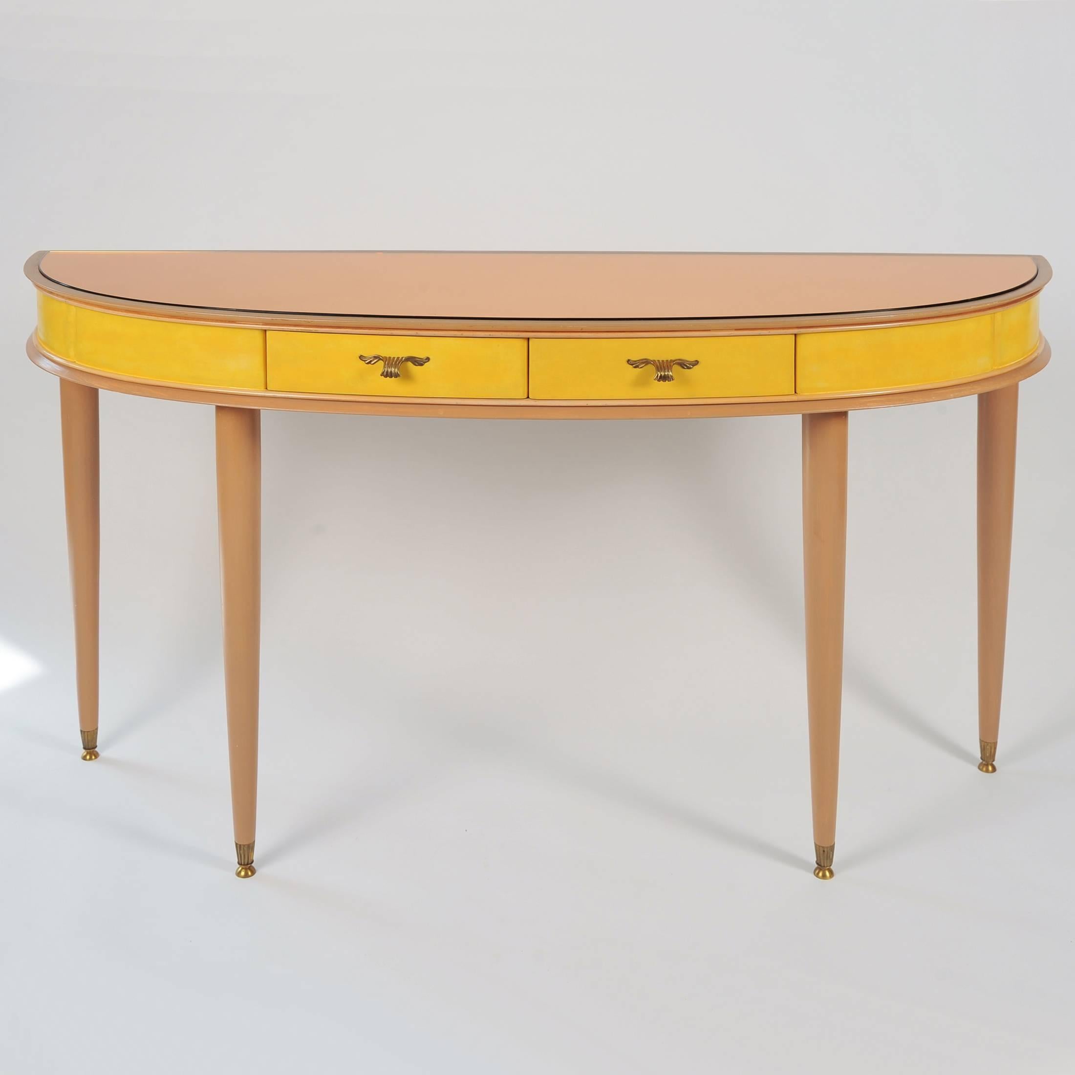 Painted fruitwood two-drawer sideboard or vanity-table on elegant tapered circular legs, with peach glass effect on top surface; the drawers and main body painted in a vivid yellow and fitted with delicate brass handles. See our separate entry for