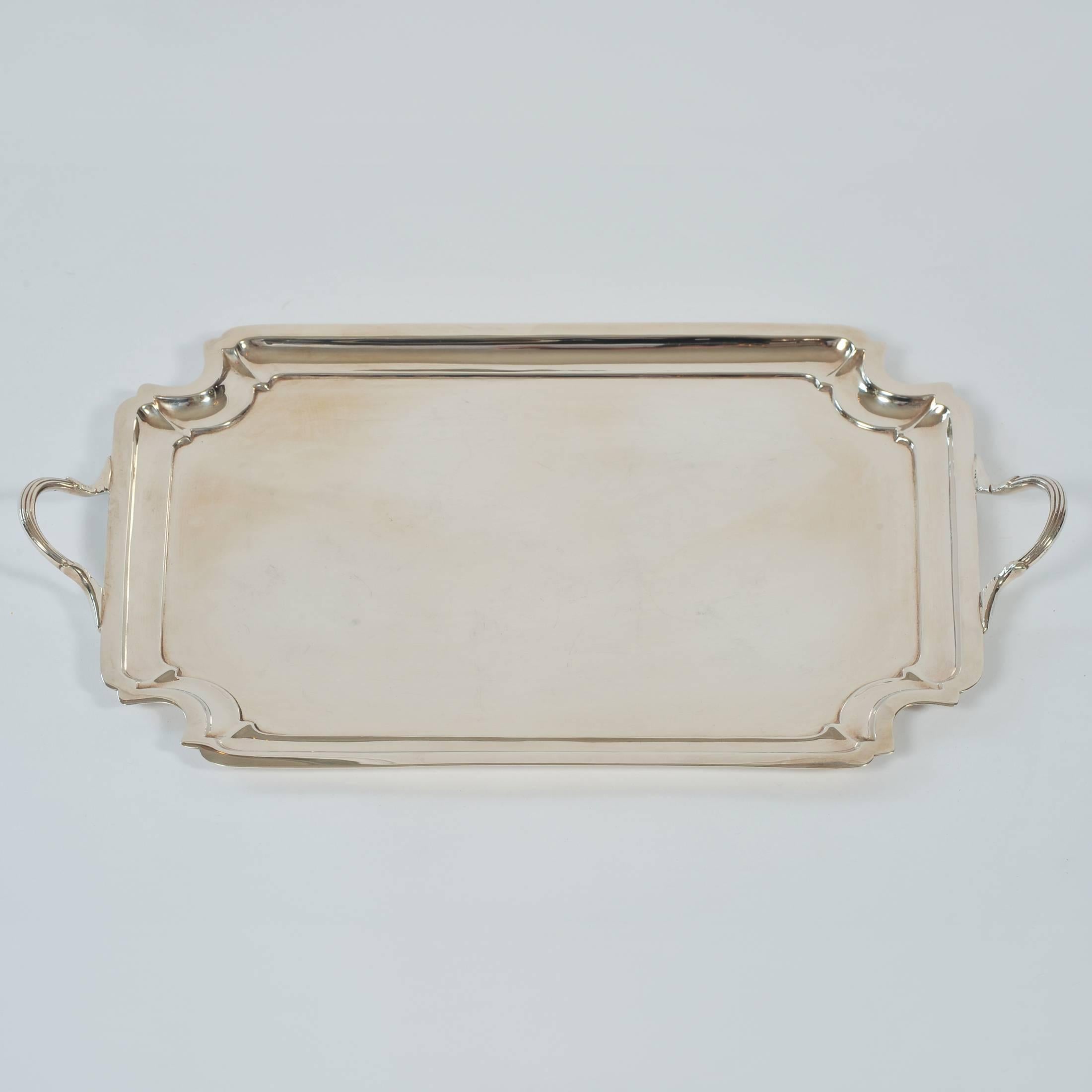 Elegant two-handled silver plate tray with simple stepped borders, stamped 'Edward & Sons, Glasgow'.