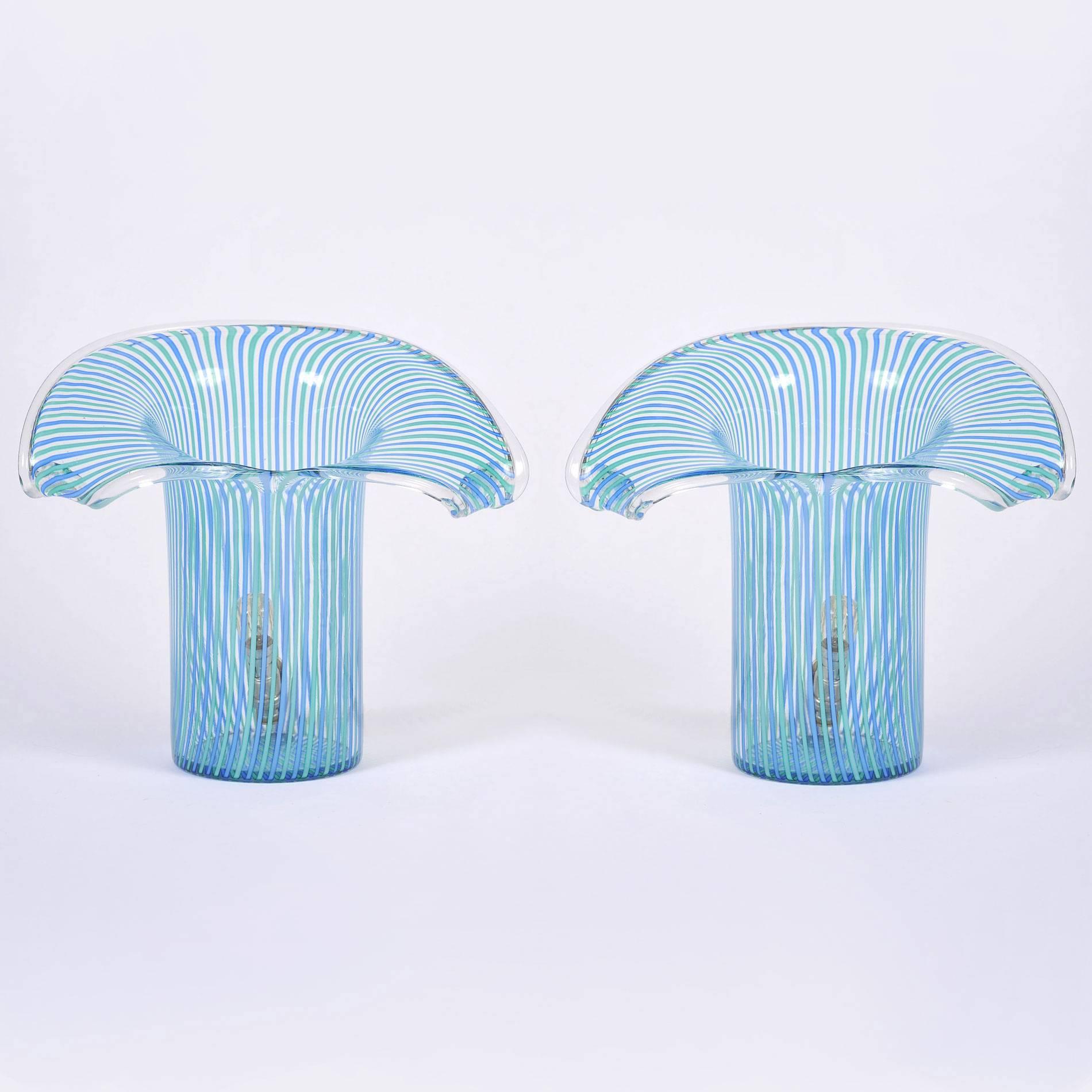 Rare cylindrical glass table lamps with open shaped top in delicately striped blue and green Murano glass.