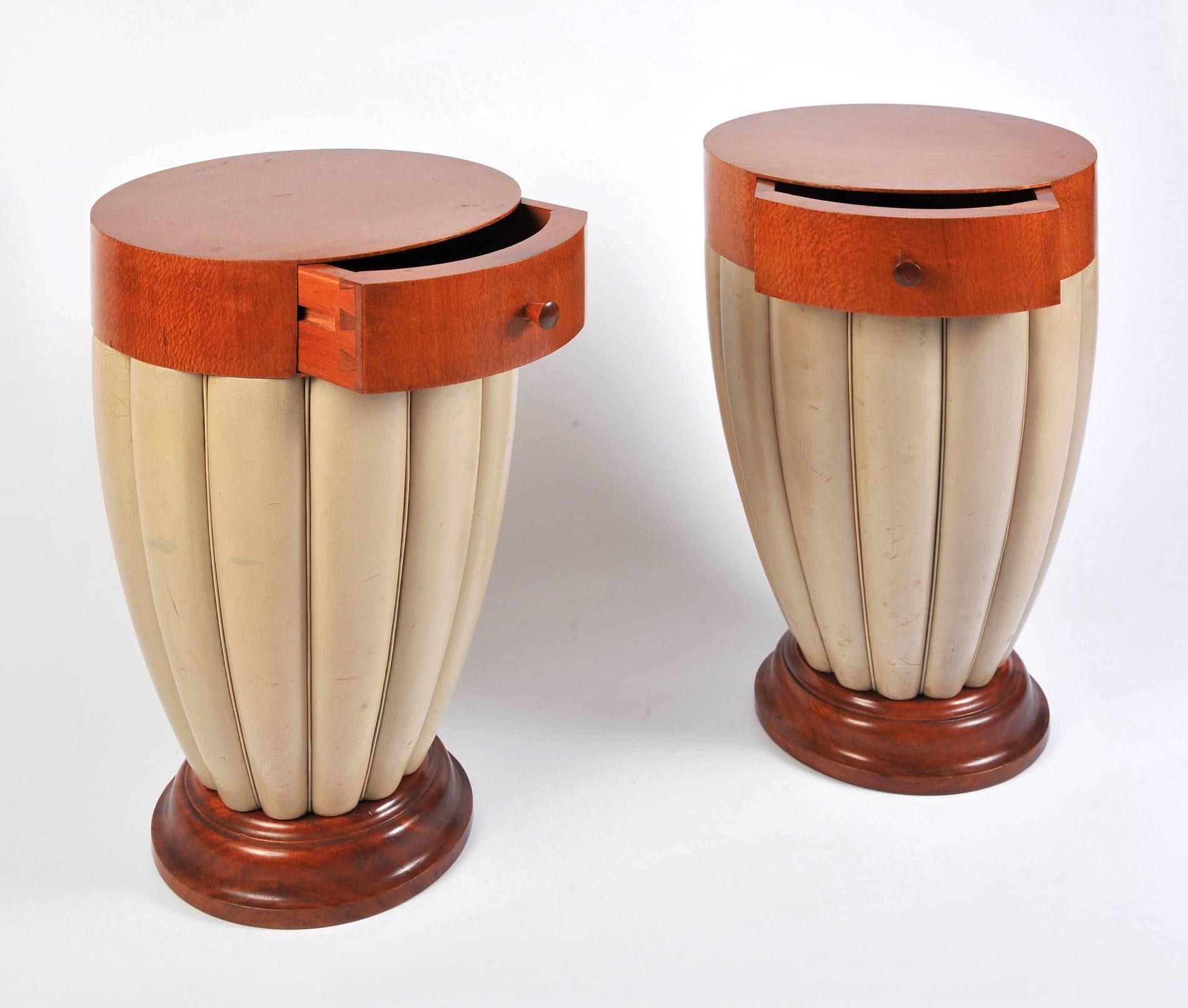 A pair of Art Deco side tables or nightstands in silky oak and off-white calf leather, dating from the mid-1920s. The fine quality of design and production could only have been conceived by a premier designer in 1920s, Paris. Interior markings