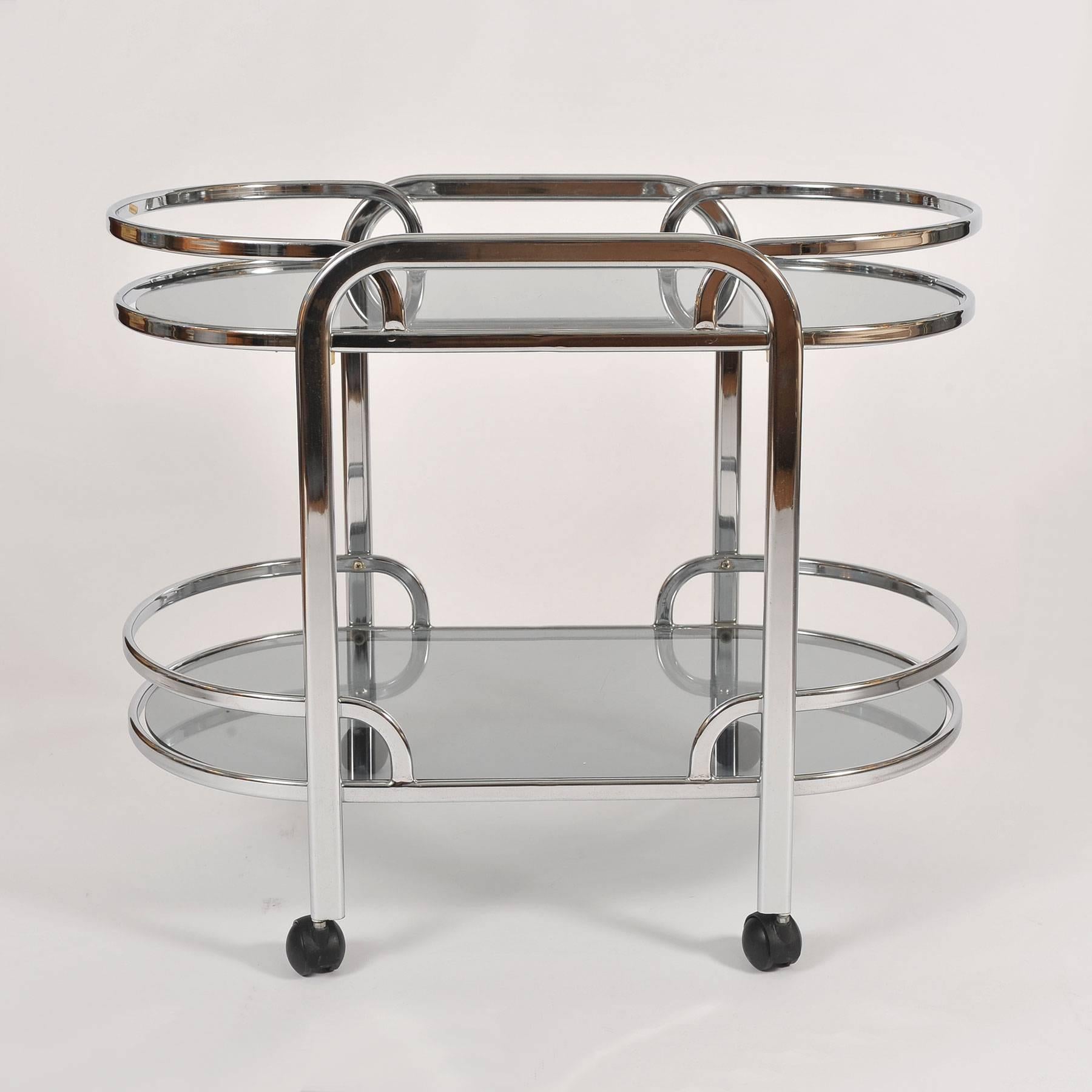Curved bar cart/drinks trolley with two smokey glass shelves, on castor wheels for smooth movement.