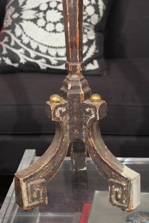 Handsome grey and gilt carved wood candle stands with very nice patina and distressing. Purchased in France, very functional as candle stands or could be wired as floor or tall table lamps.