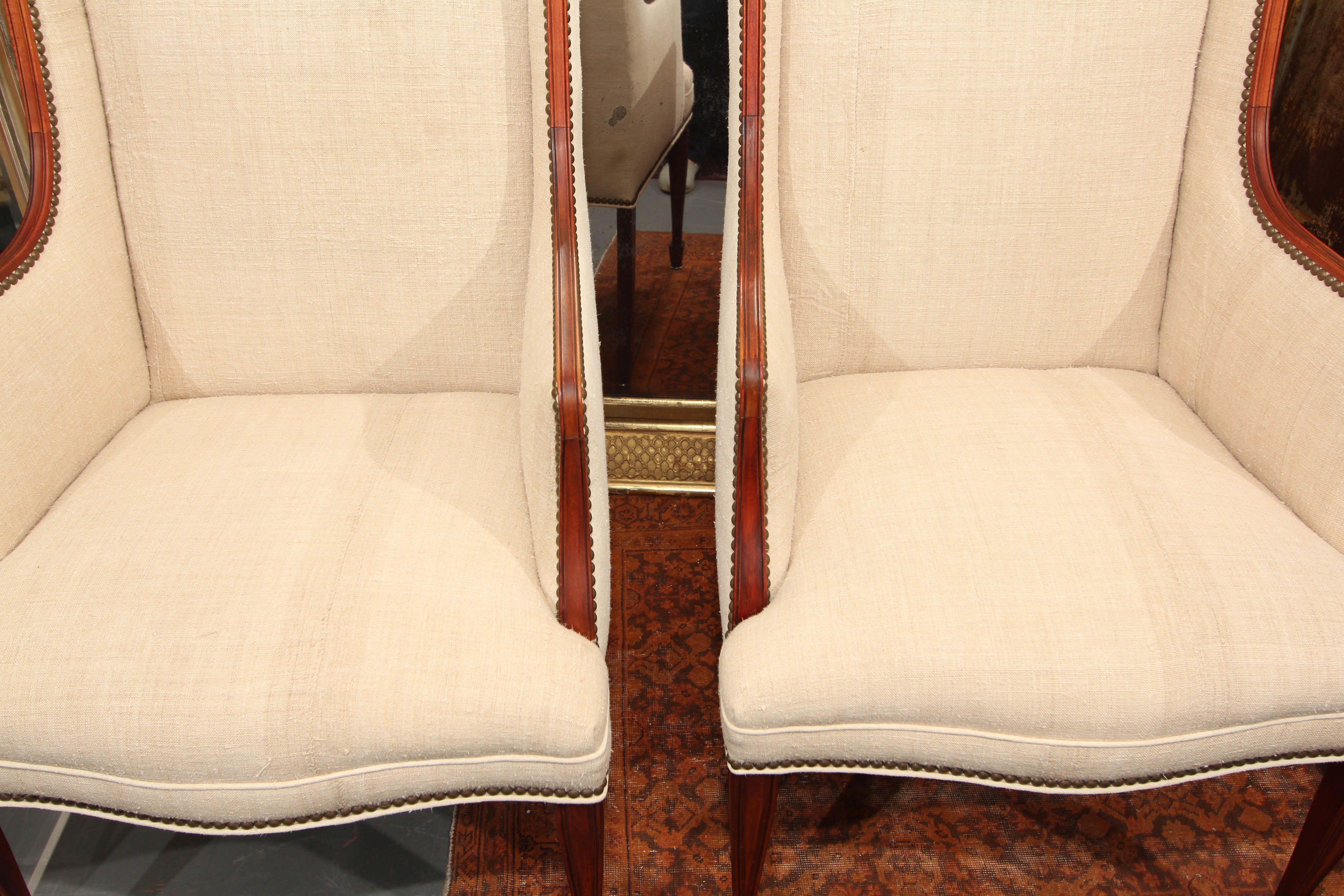 Comfortable pair of high backed mid century side chairs reupholstered in heavy hand loomed linen and trimmed in nailheads.  Very versatile form and size