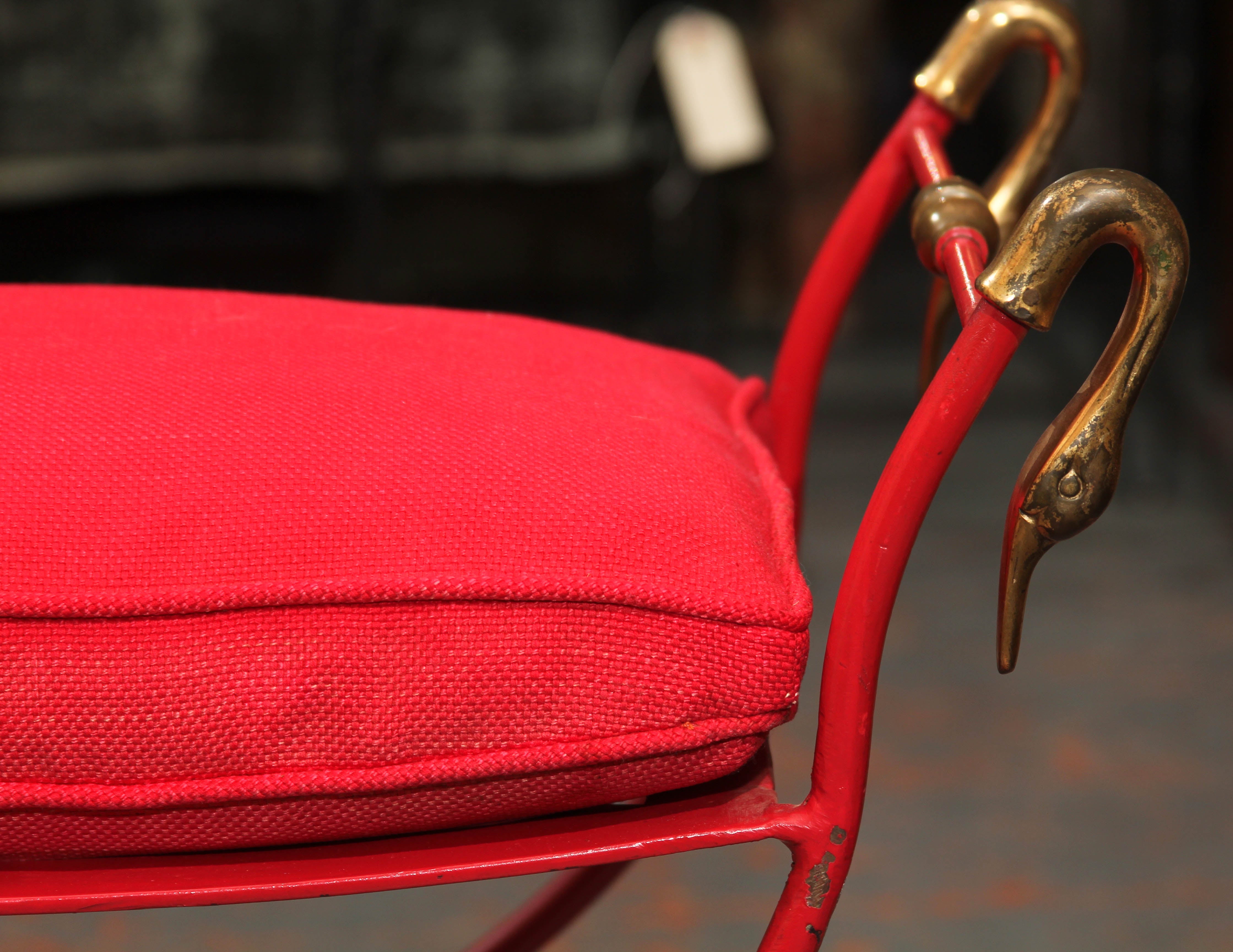 Small iron Italian bench in red with gold accents. Down or feather cushion in red linen.