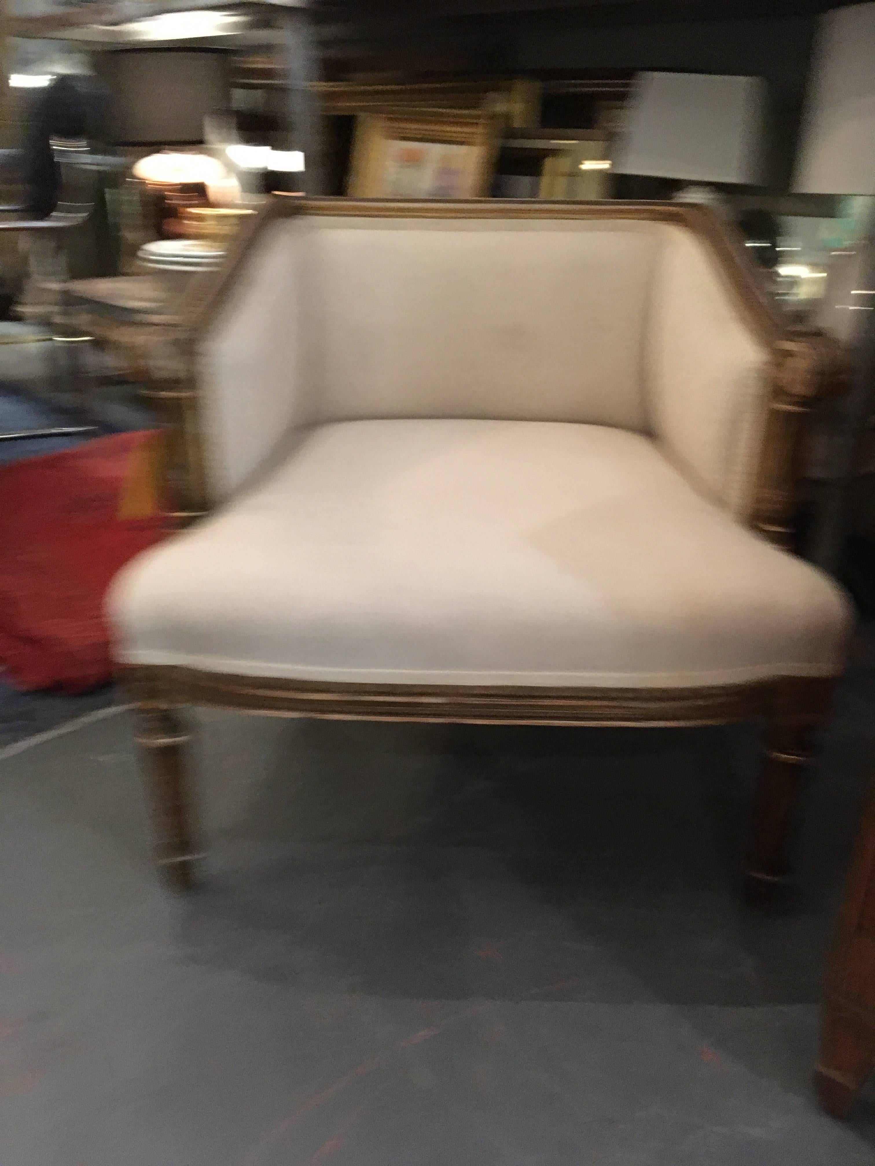 Lovely small antique French chair that looks great and is sturdy and comfortable. Hand-carved wood frame with worn gilding and muslin upholstery.